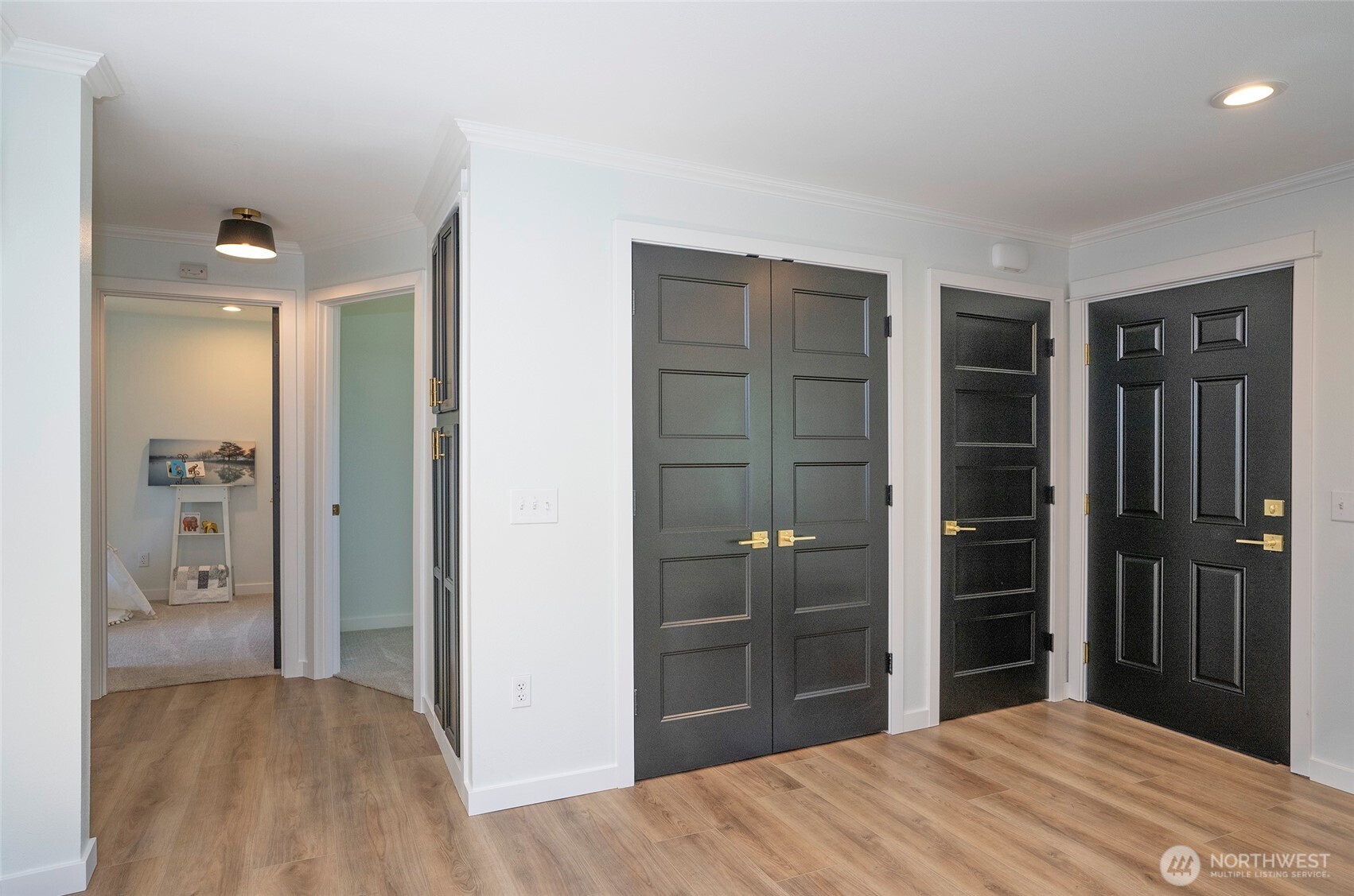 Behind the double doors, the space is made perfectly for your stackable washer and dryer.