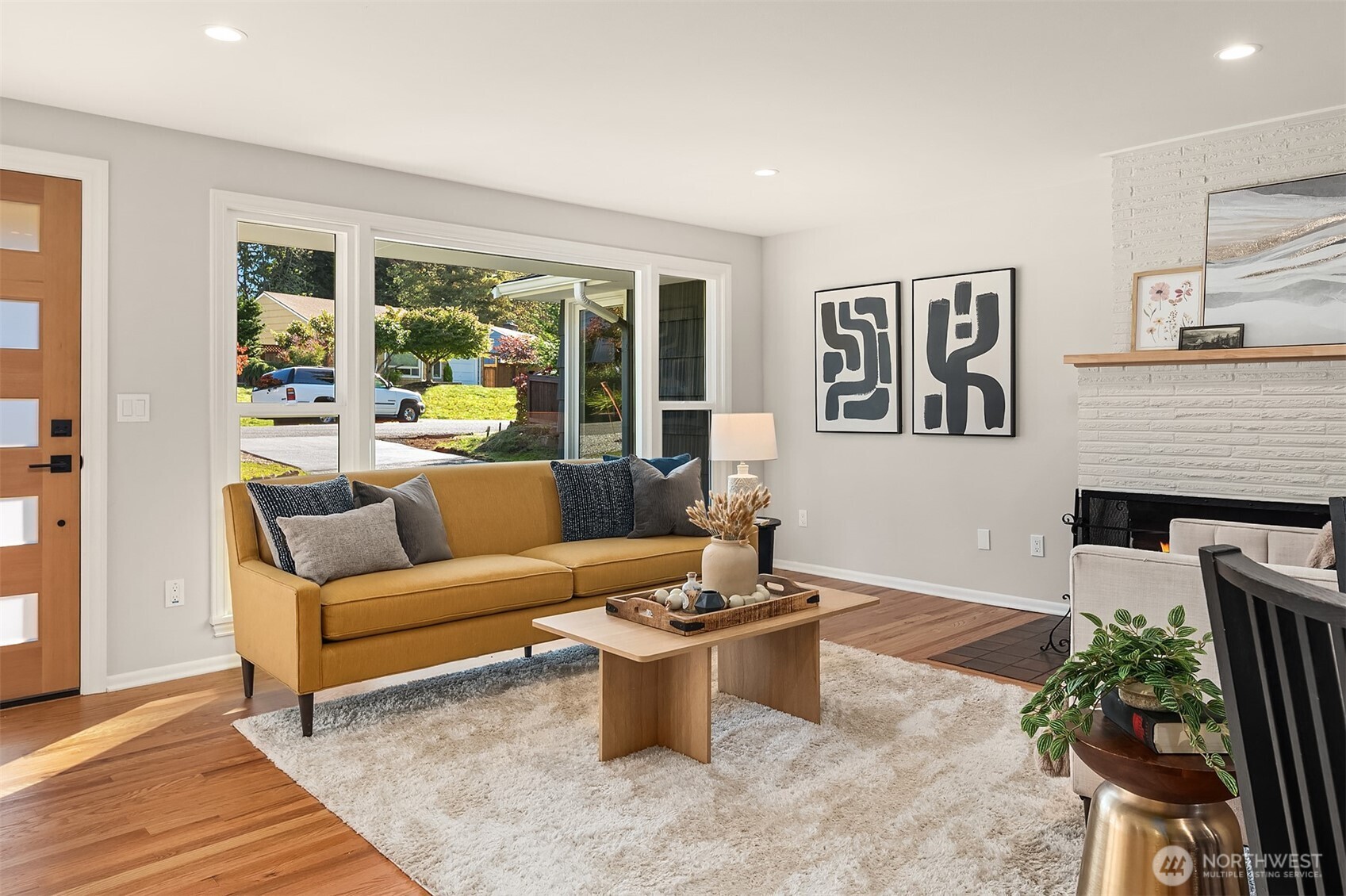 Open and inviting living room has a huge window to let all the sunshine in. Picture from previous listing