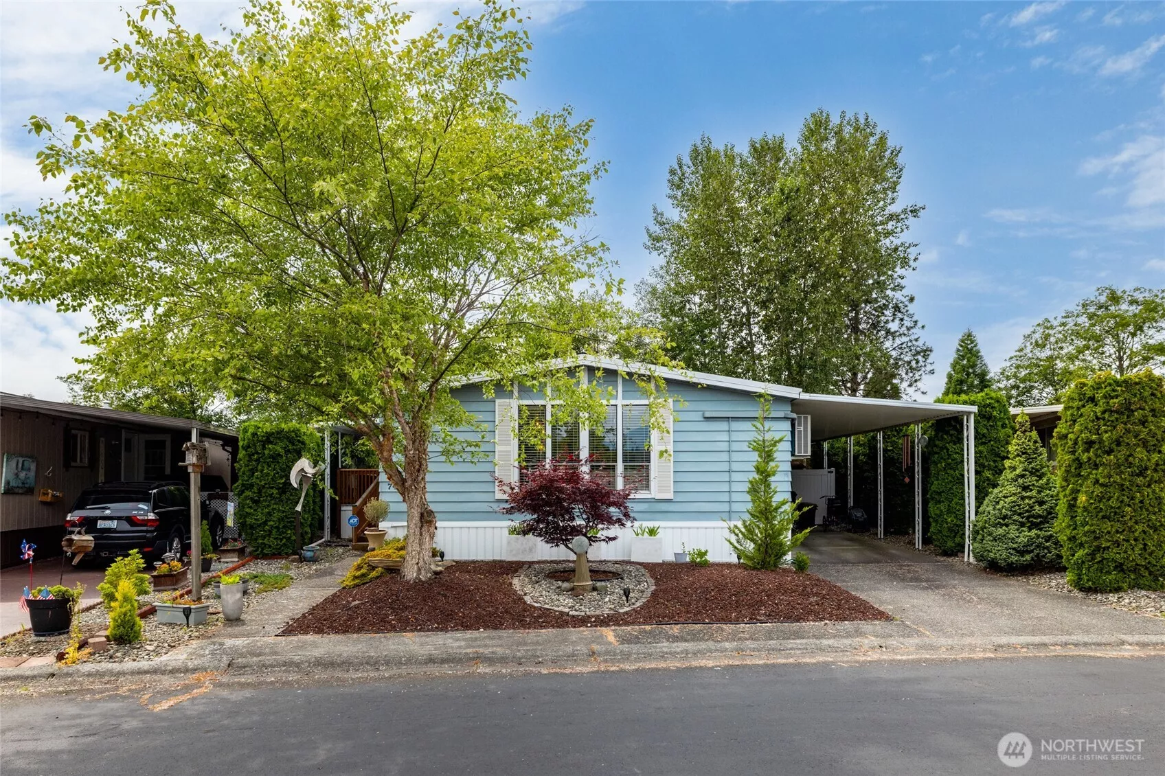 Welcome to #74, your oasis in the quiet and secure 55+ neighborhood of Park Village!