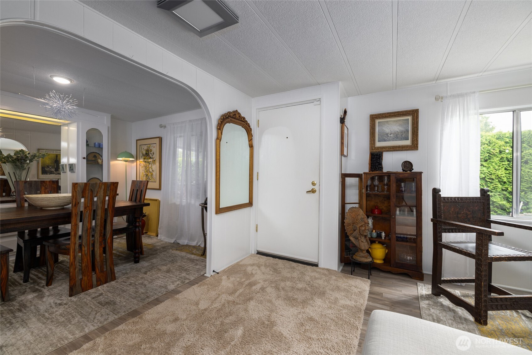Looking back at the front door, with formal dining room to the left, and living room to the right.