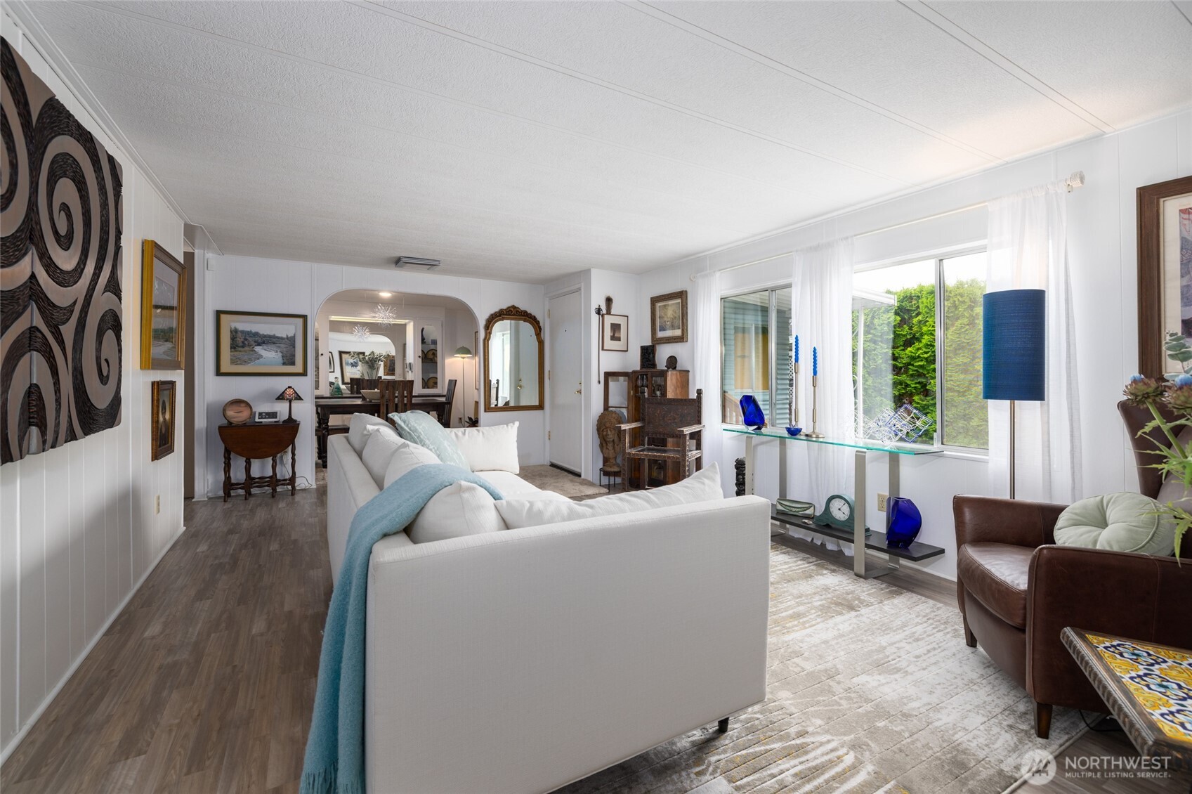 A view of the front living room, with the formal dining in the background