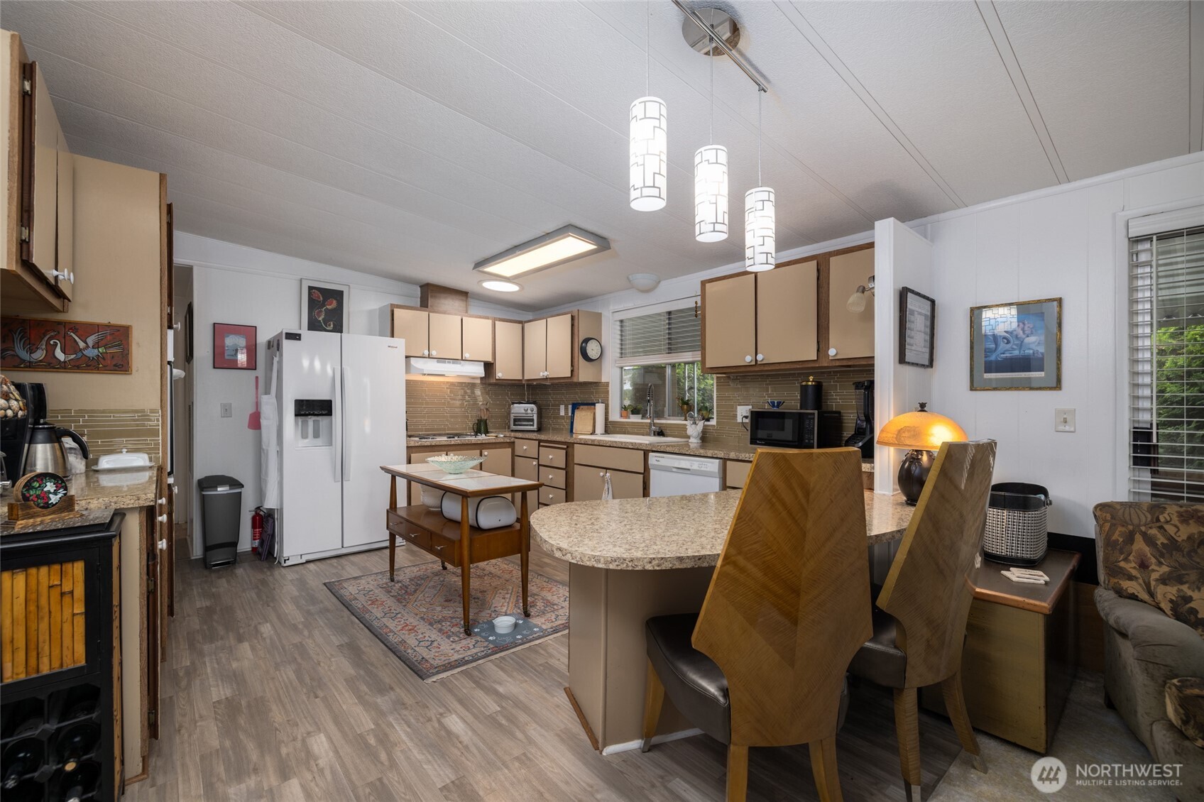 Eat-in kitchen space. All custom light fixtures throughout the home.