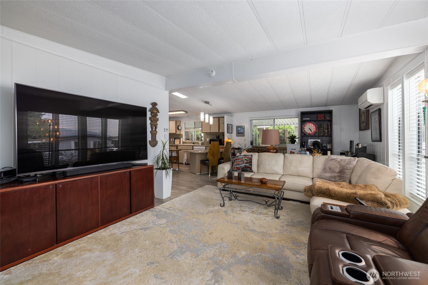 In the second living room, looking back toward the kitchen. Note the mini-split unit. This home has a newer furnace in addition, with air conditioning/heat pump. You'll always be able to keep a comfortable environment!