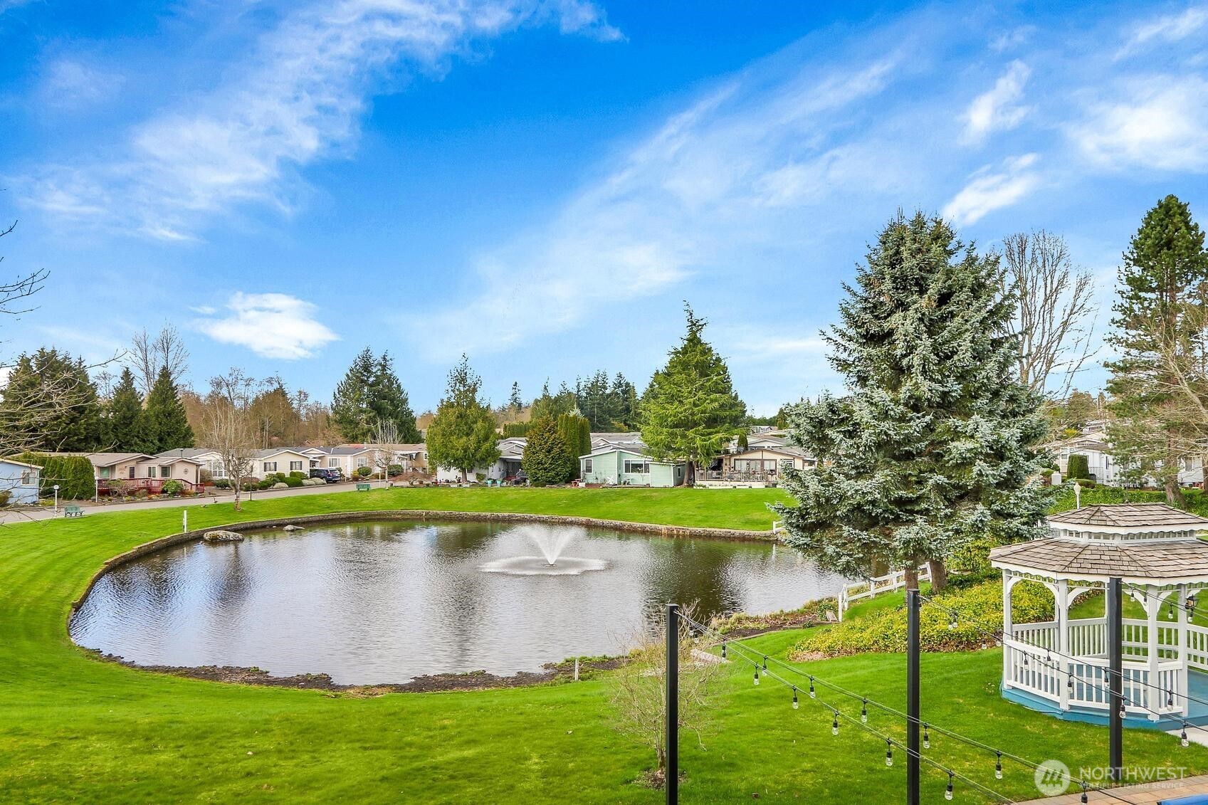 Community Pond surrounded by lush landscaping & bench seating!