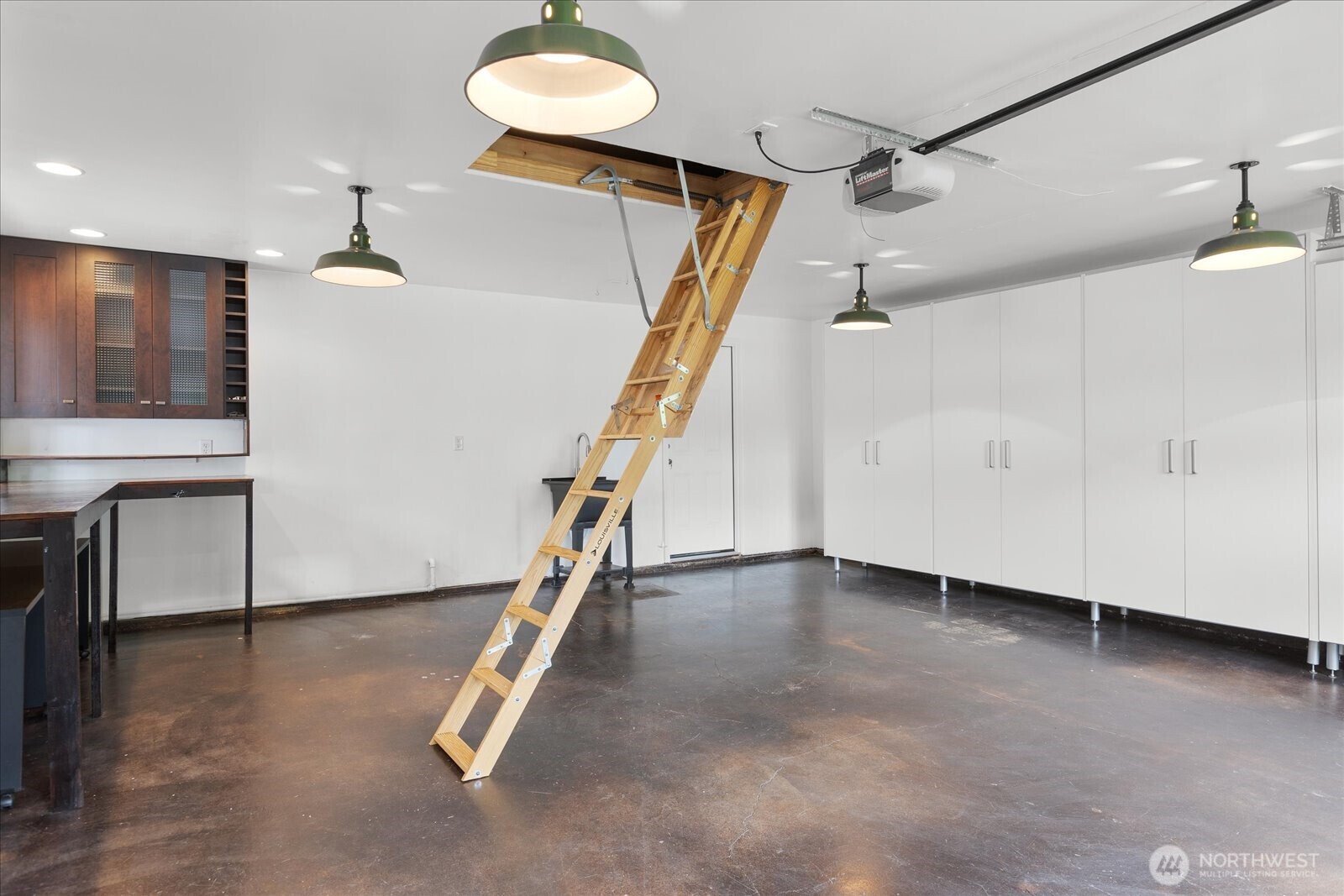 Pull-down ladder accesses extra attic storage space.
