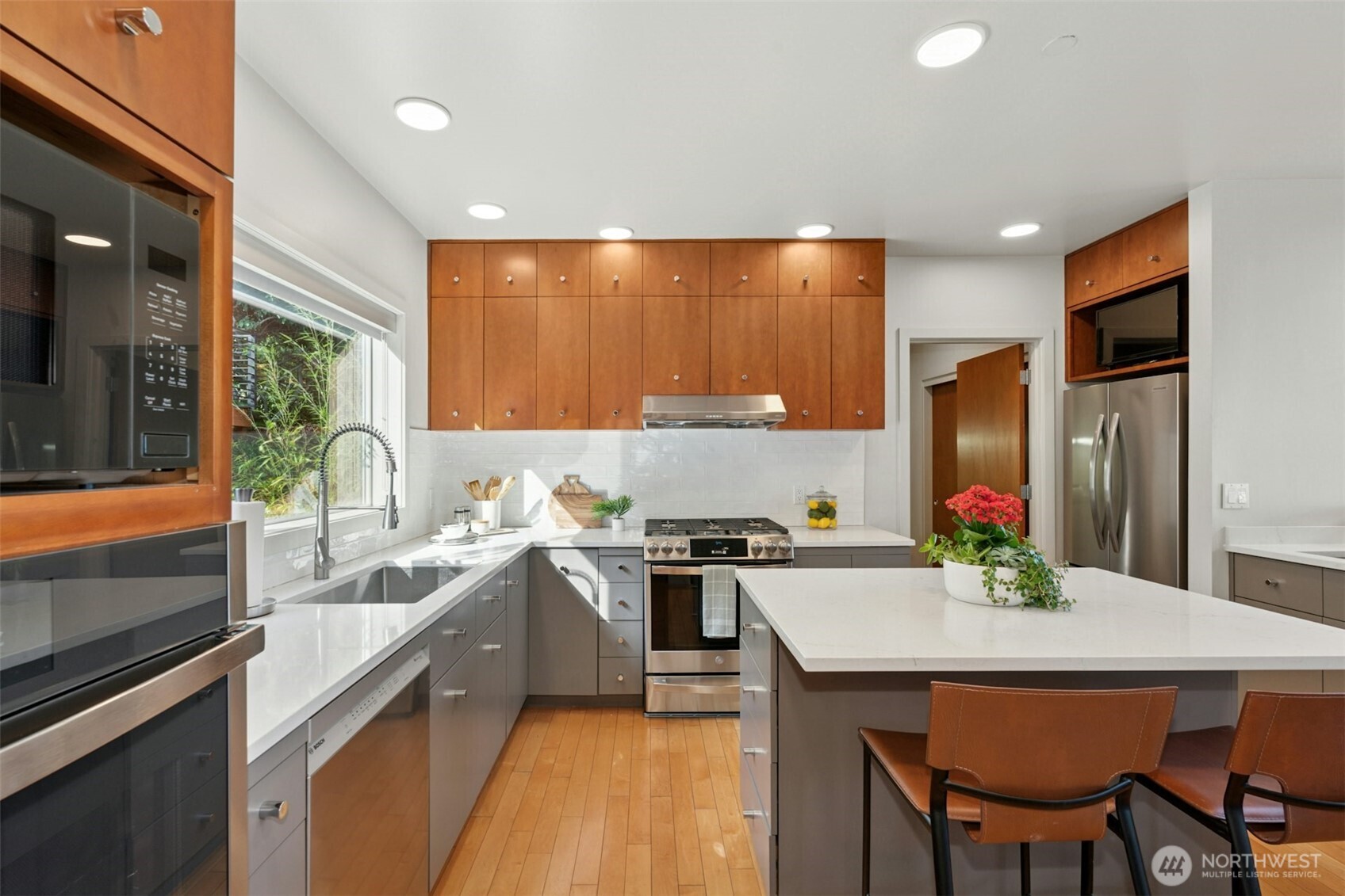 Kitchen includes wet bar & island with seating
