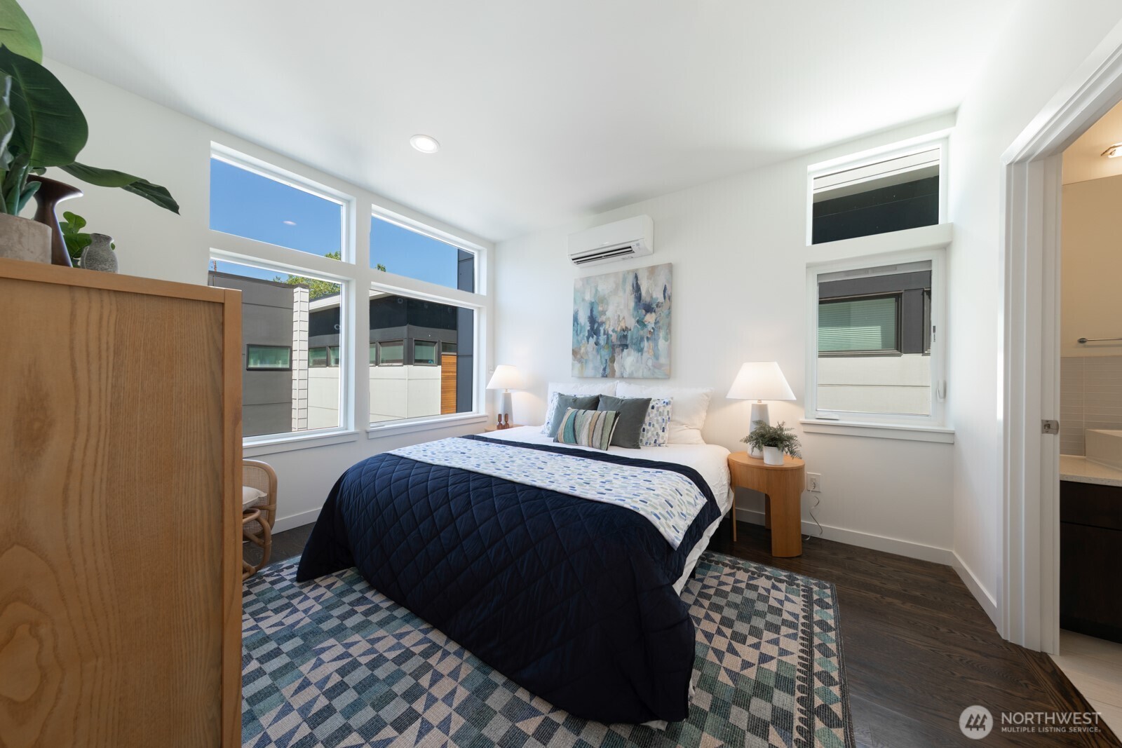 Primary suite on the upper level with abundant windows.