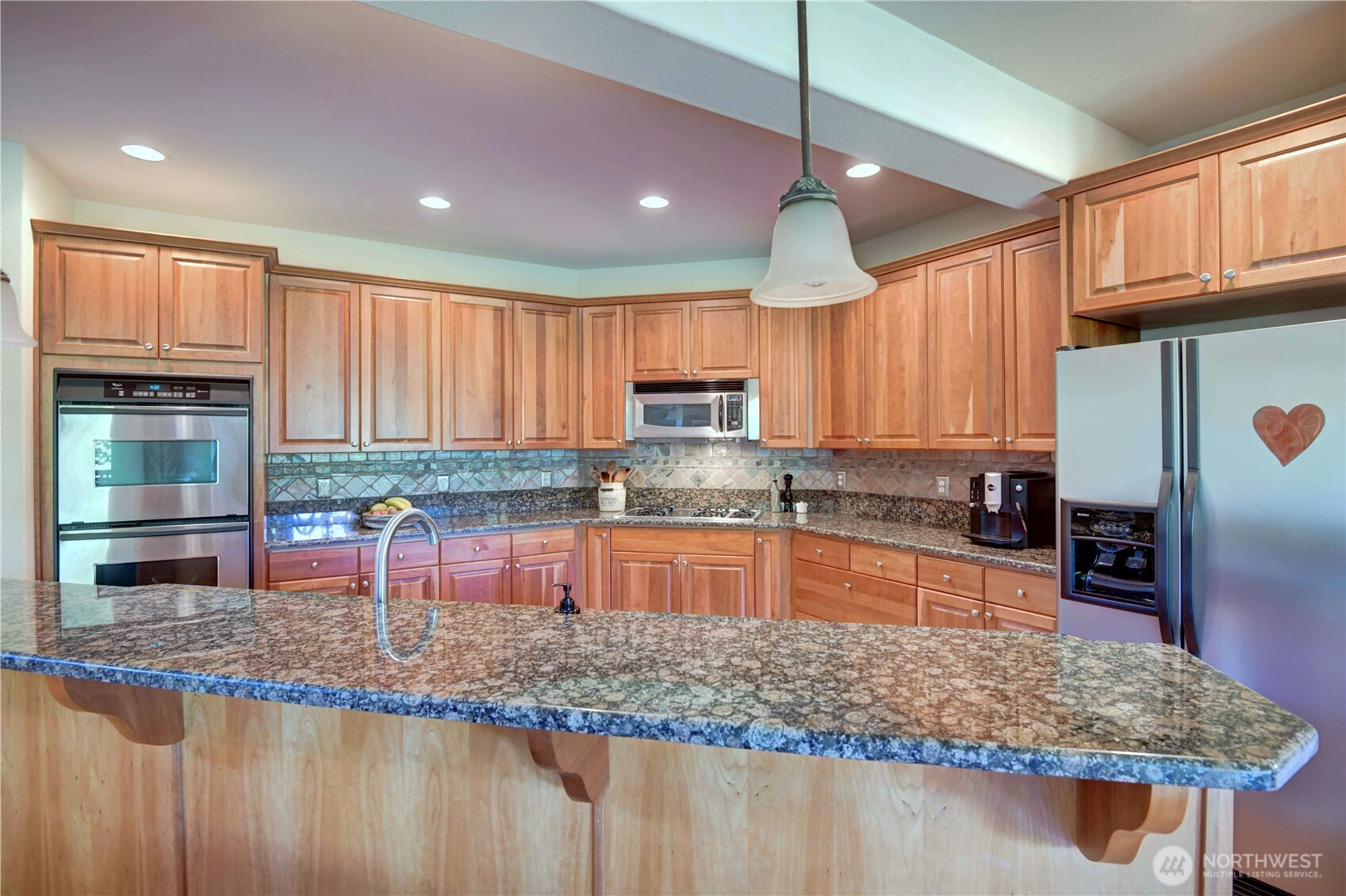 Kitchen with Stainless steel 4 gas burners cooktop.