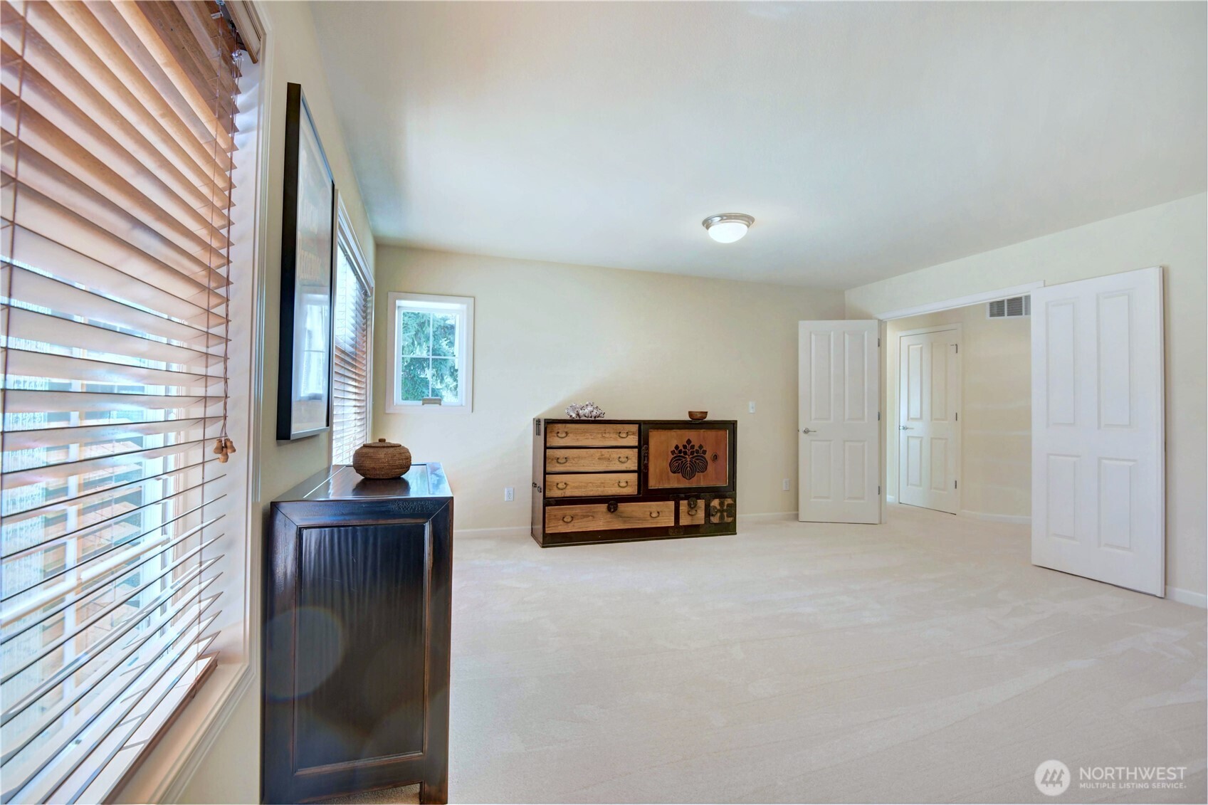 Huge media room upper floor with French door access to a balcony in front.