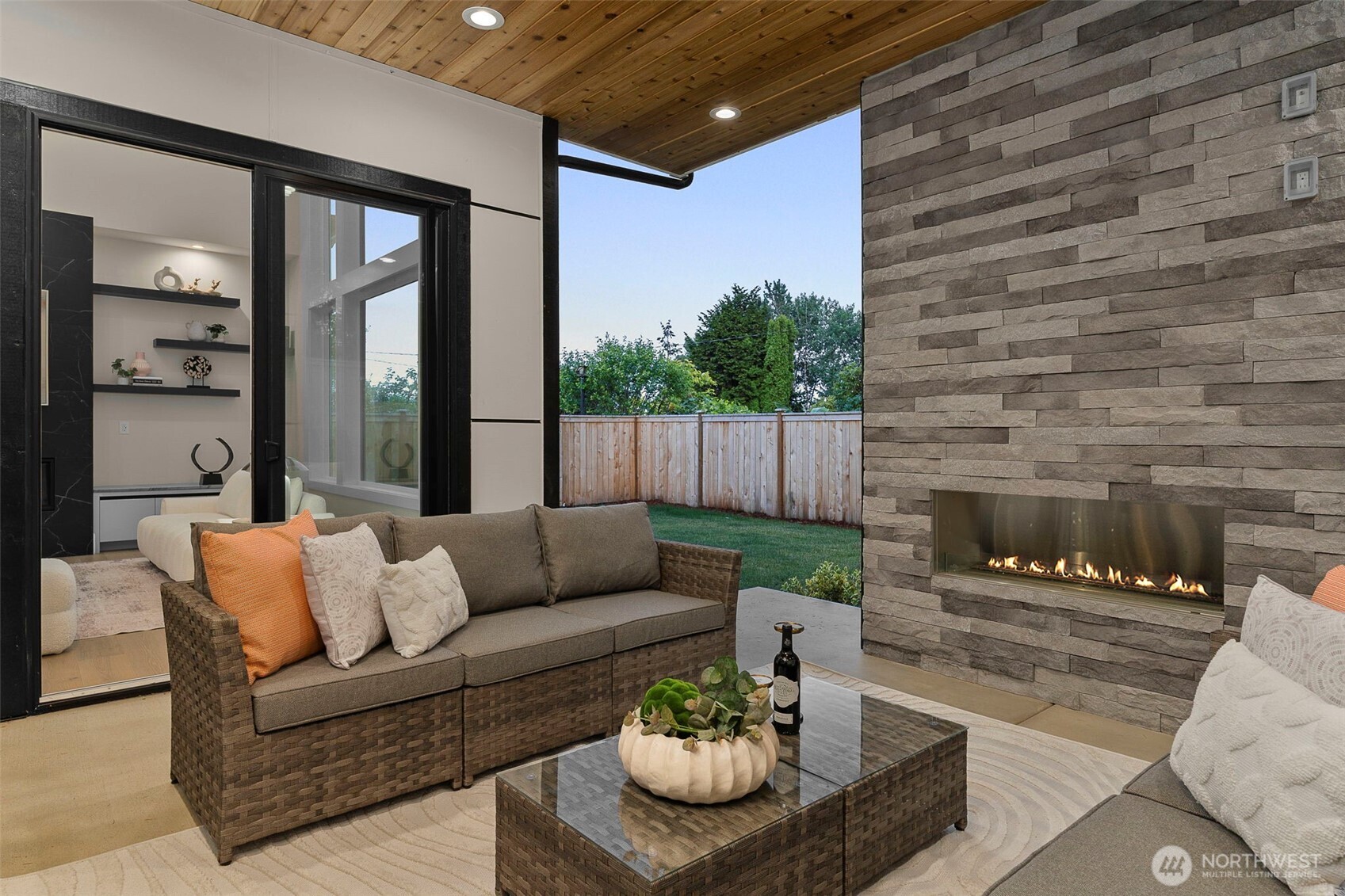 Covered outdoor living with gas fireplace and electric heaters