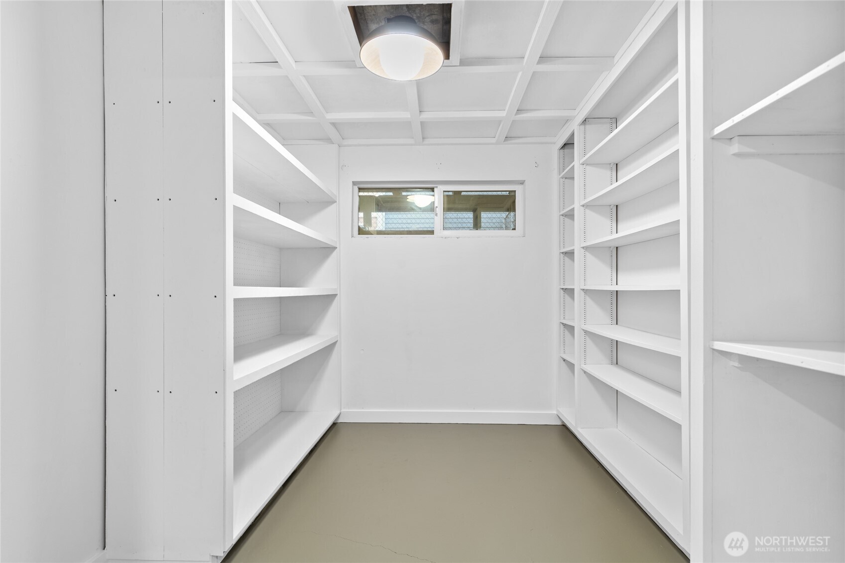 Lower-level storage room with new paint, lighting and flooring.