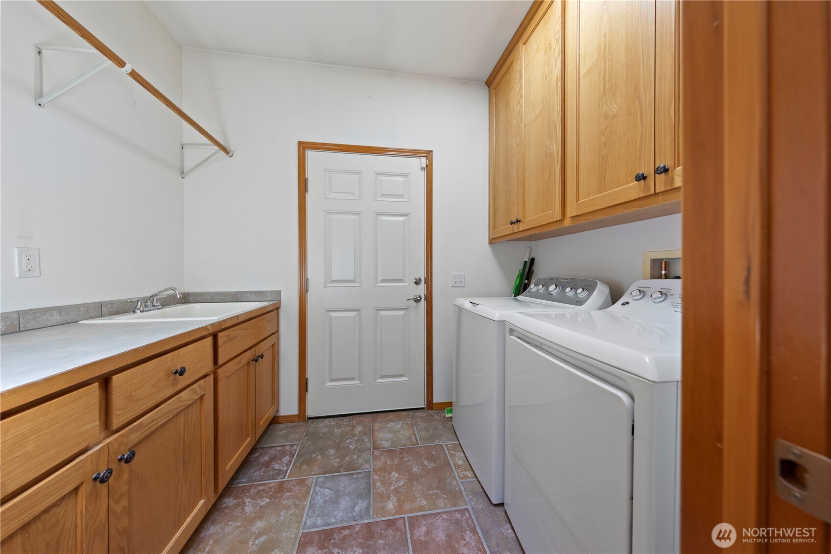 Large laundry/utility room with sink and cabinetry.