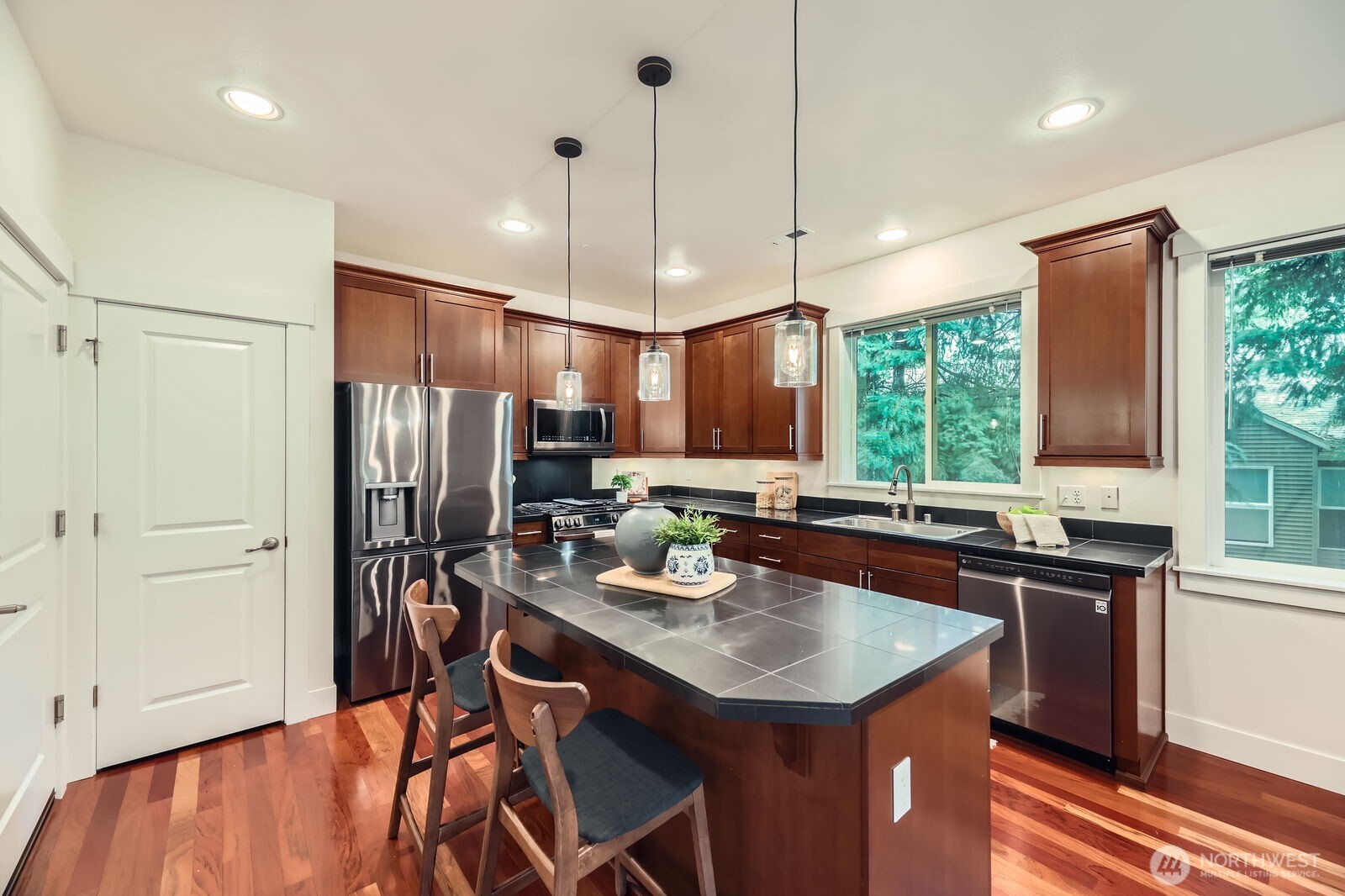 Gunmetal stainless LG appliances, pantry, pendant lighting, deep sink and gas range.