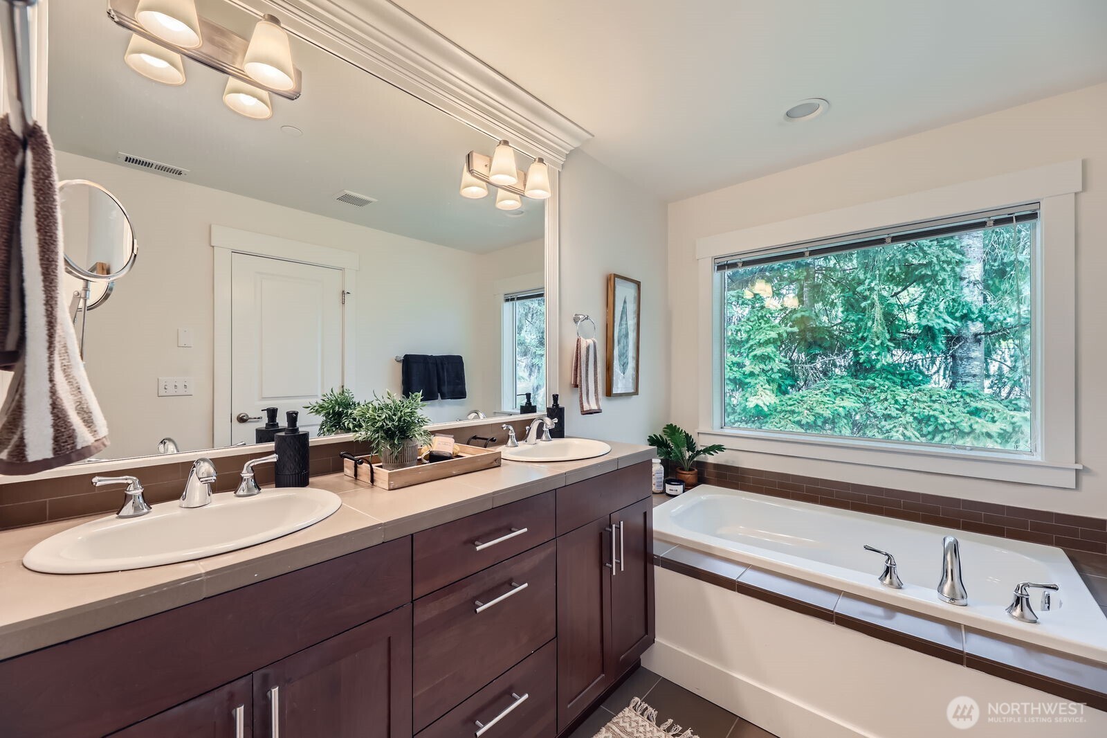 5 Piece bath off main primary suite. Soaking tub, dual vanity, tile counters and separate shower.