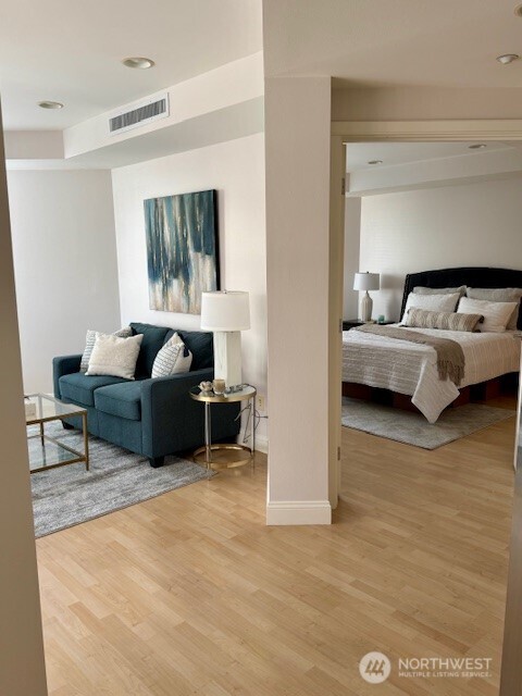 The dining area is conveniently located off of the kitchen and living area with a wall of floor-to-ceiling windows and glass French doors leading to the view balcony.
