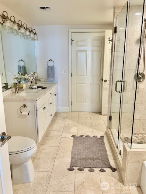 The newly remodeled kitchen is beautifully appointed with Quartzite counters, stainless steel appliances and custom cabinets.