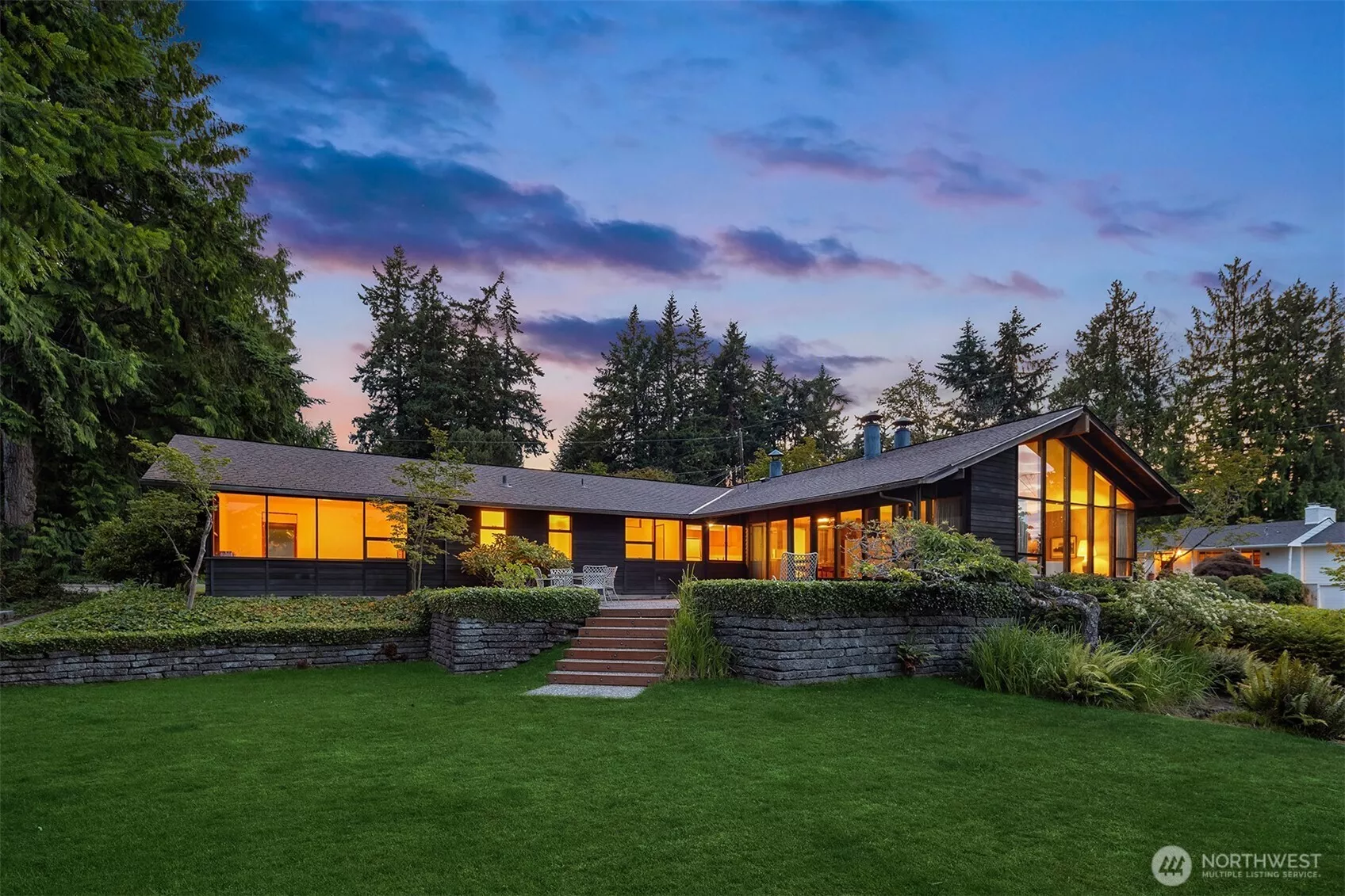 Floor-to-vaulted-ceiling windows offer sunrise views.