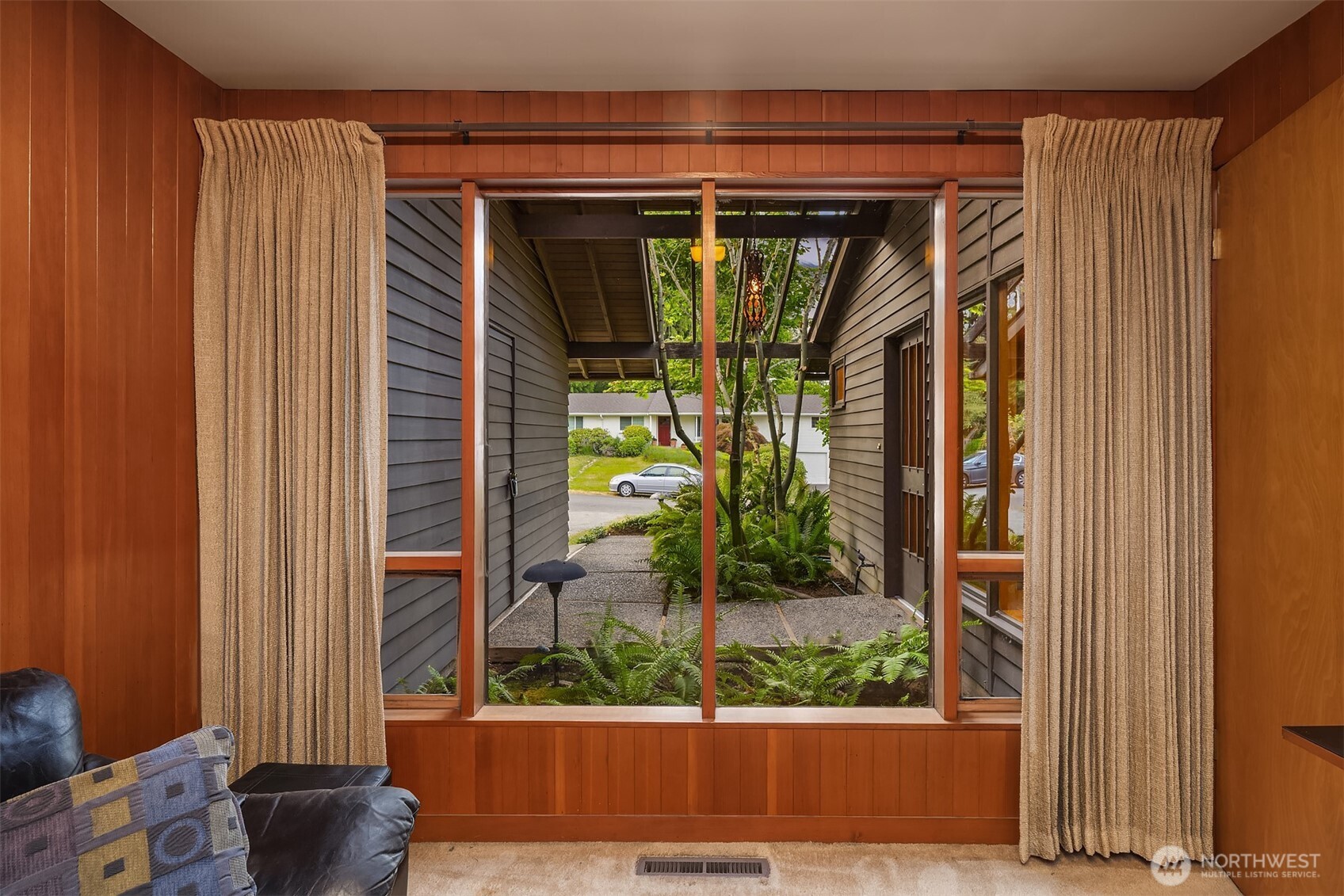 The den looks out onto the entry courtyard.