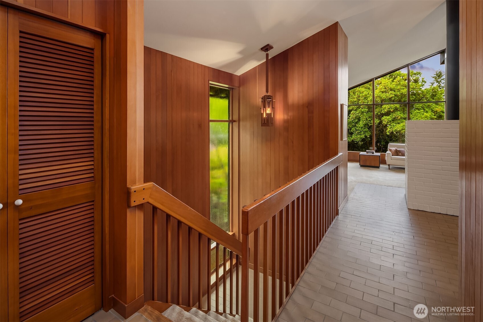 The interior entry features custom wood lights that throw changing shadows on the ceilings.