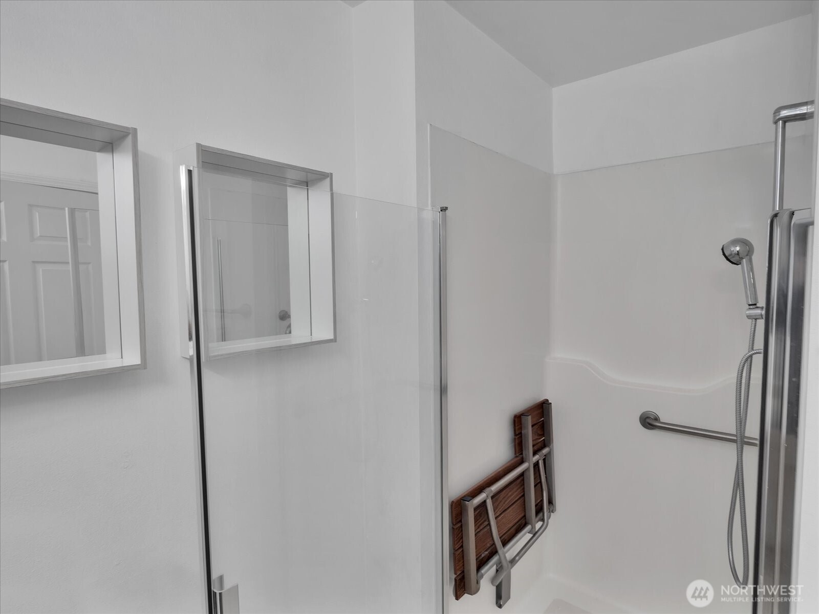 Second bathroom has accessible shower with pull-down shower bench.