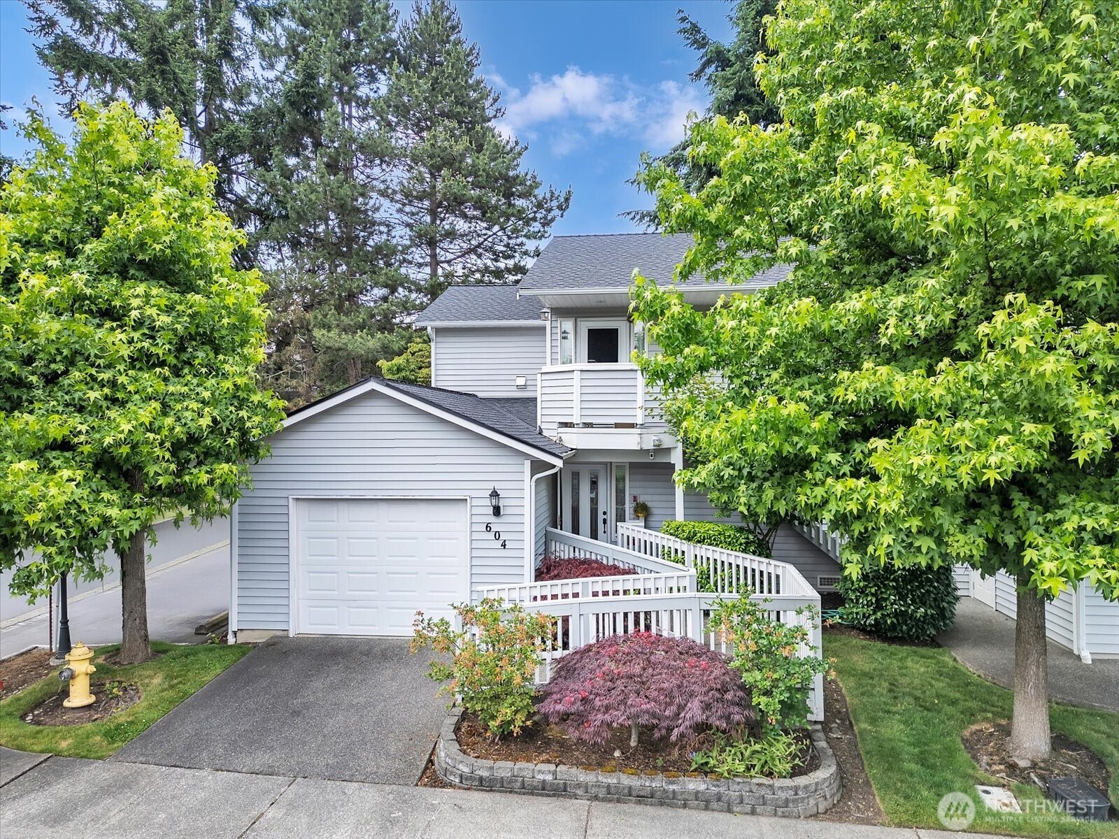 Single car garage with to park a car in driveway by ramp.