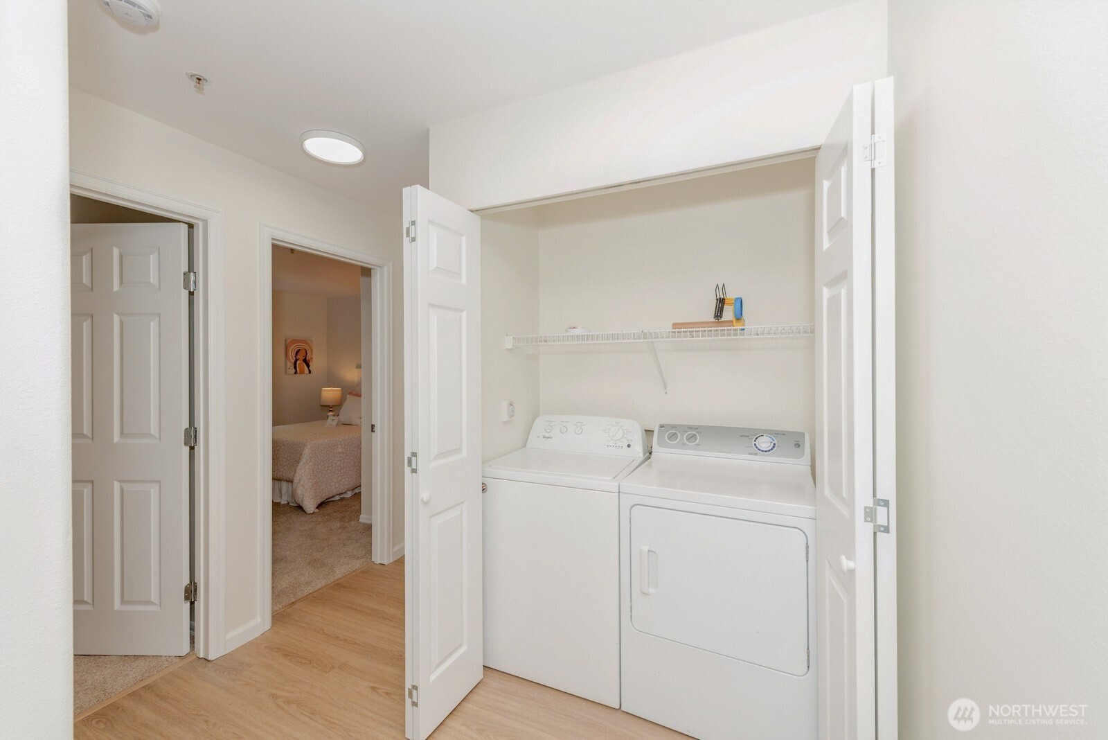 Laundry closet with washer and dryer.