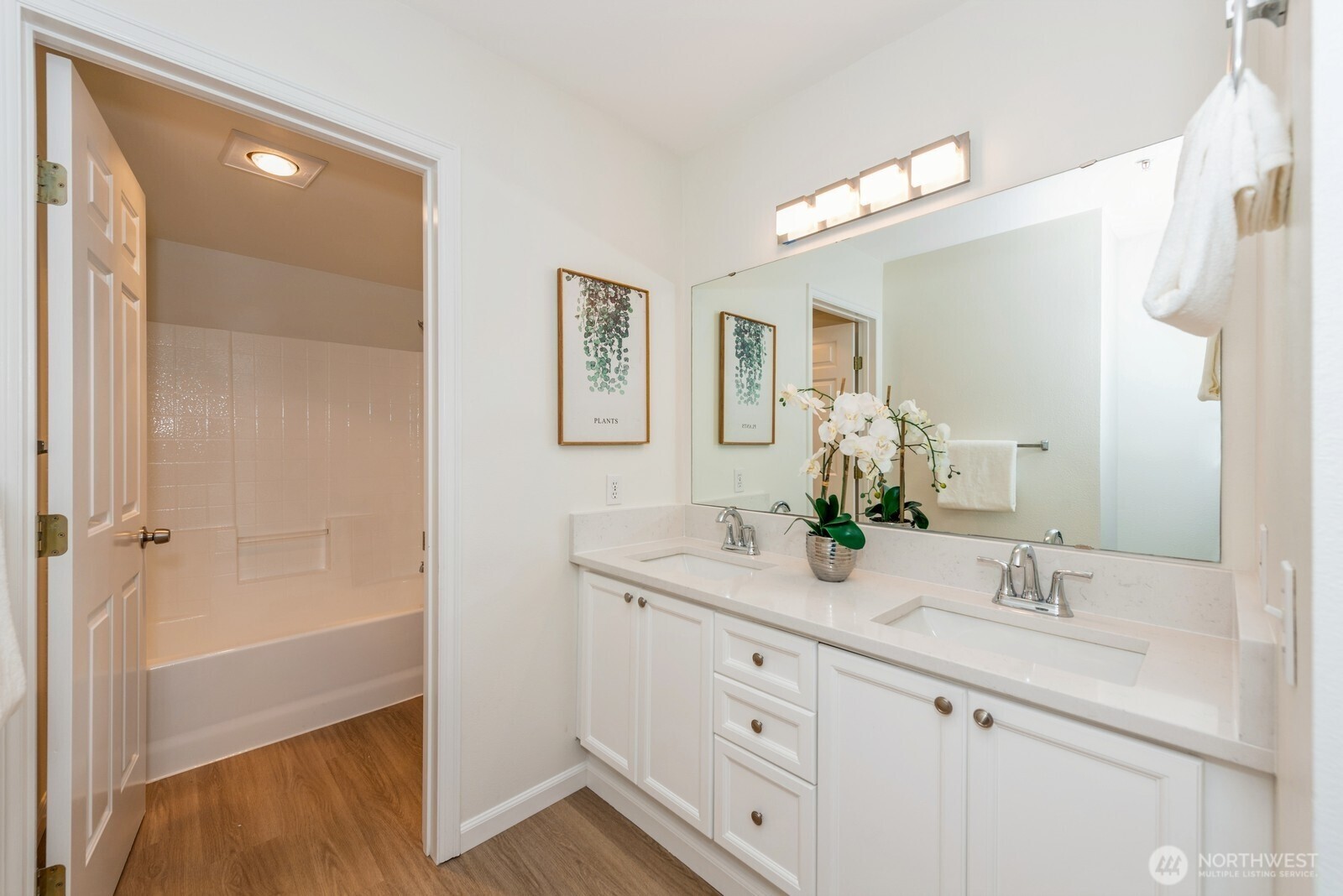 Vanity with 2 sinks and ample countertop space.