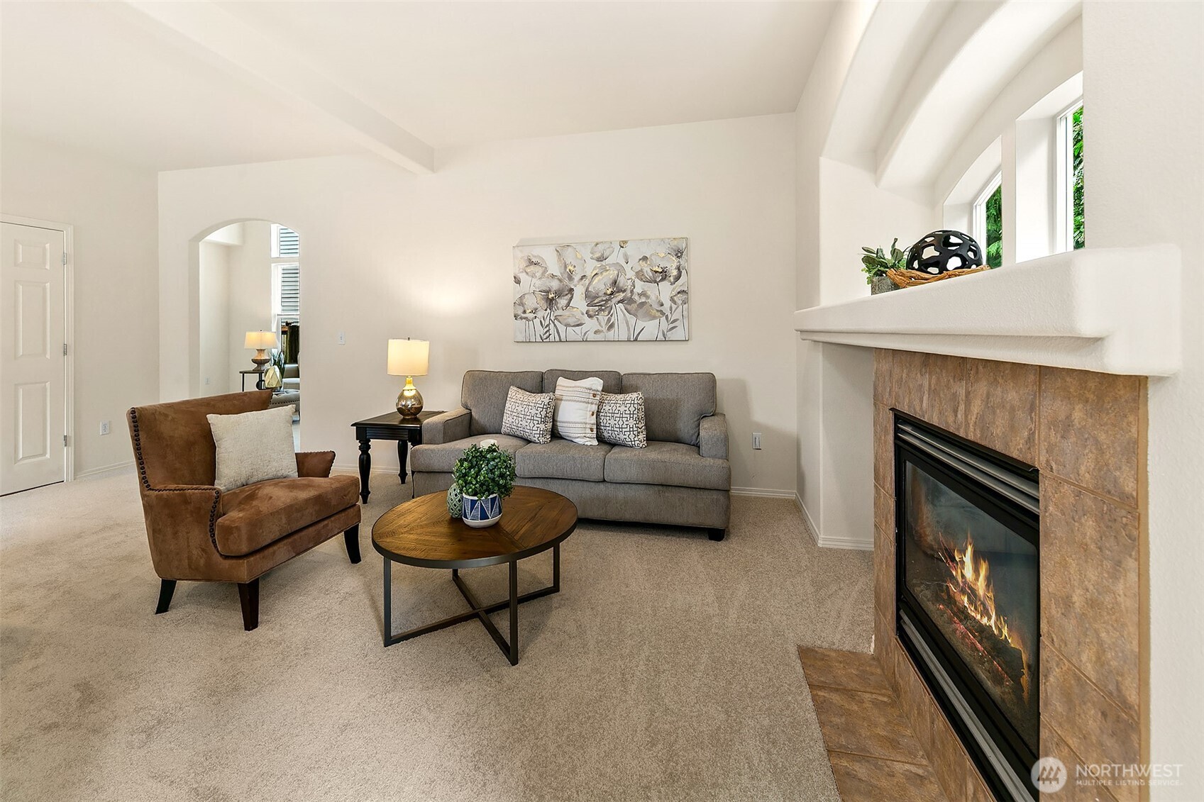 Gas log fireplace and arched window.