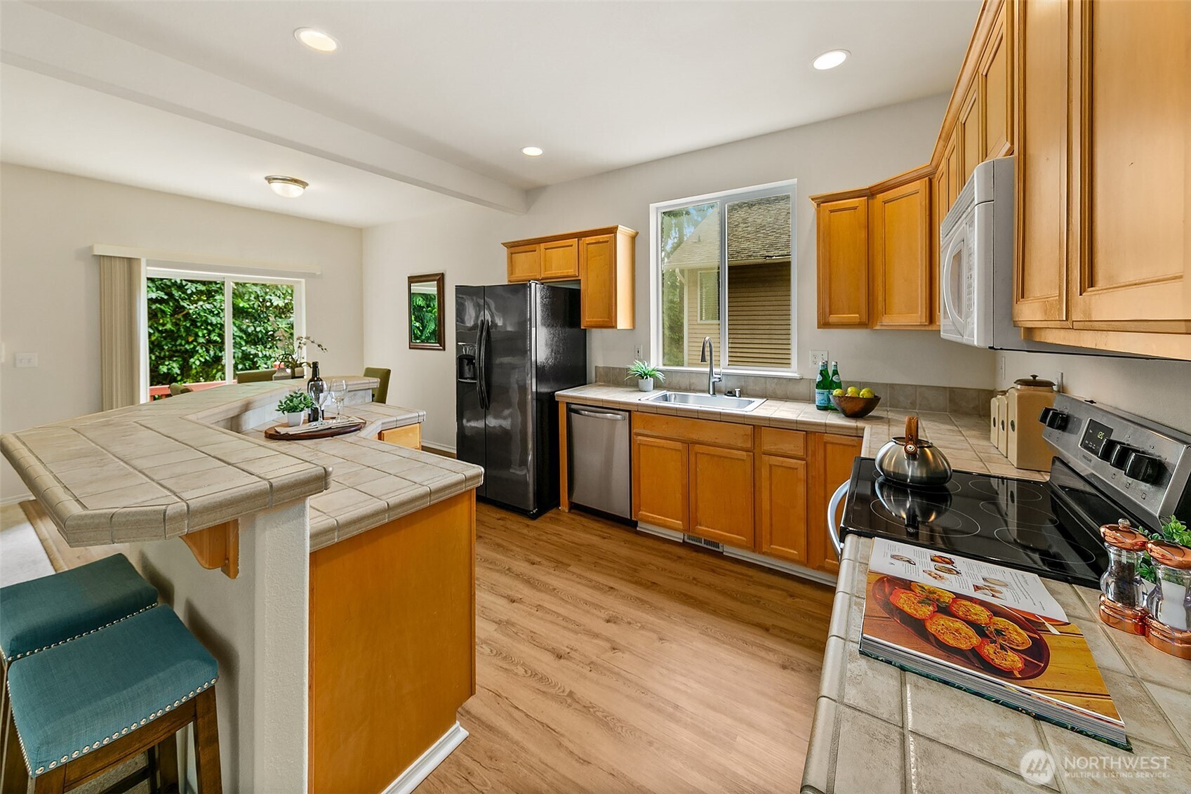Spacious kitchen with tile island and eating bar.