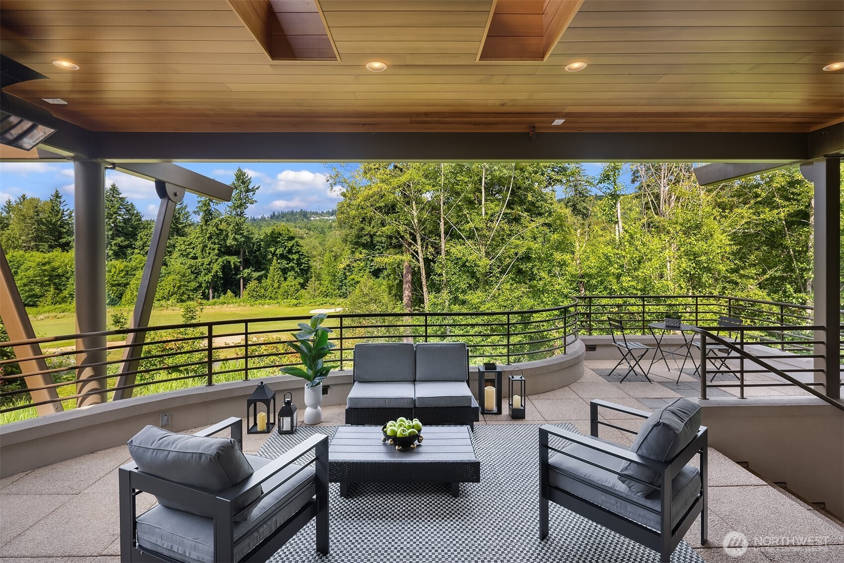 The main floor, covered, sky-lit deck with multiple space for relaxing, dining-steps to right down to hot tub