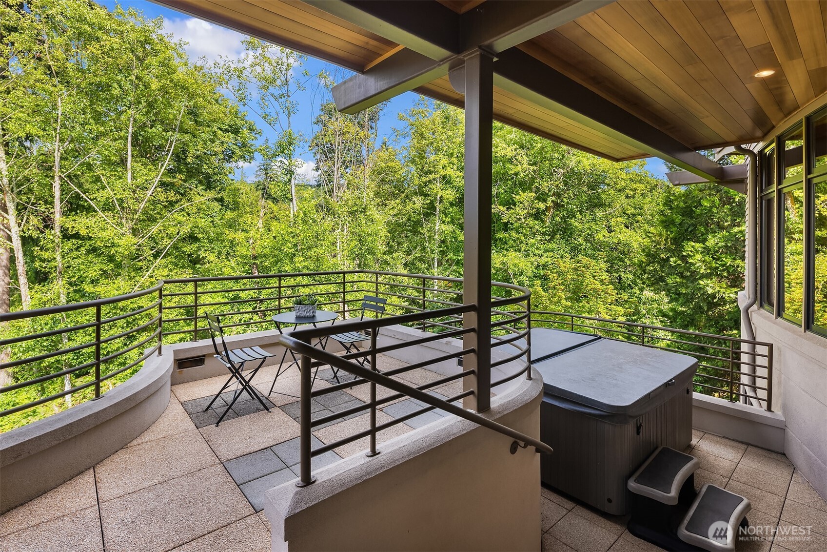 A few steps down from the main floor deck is a private hot tub space