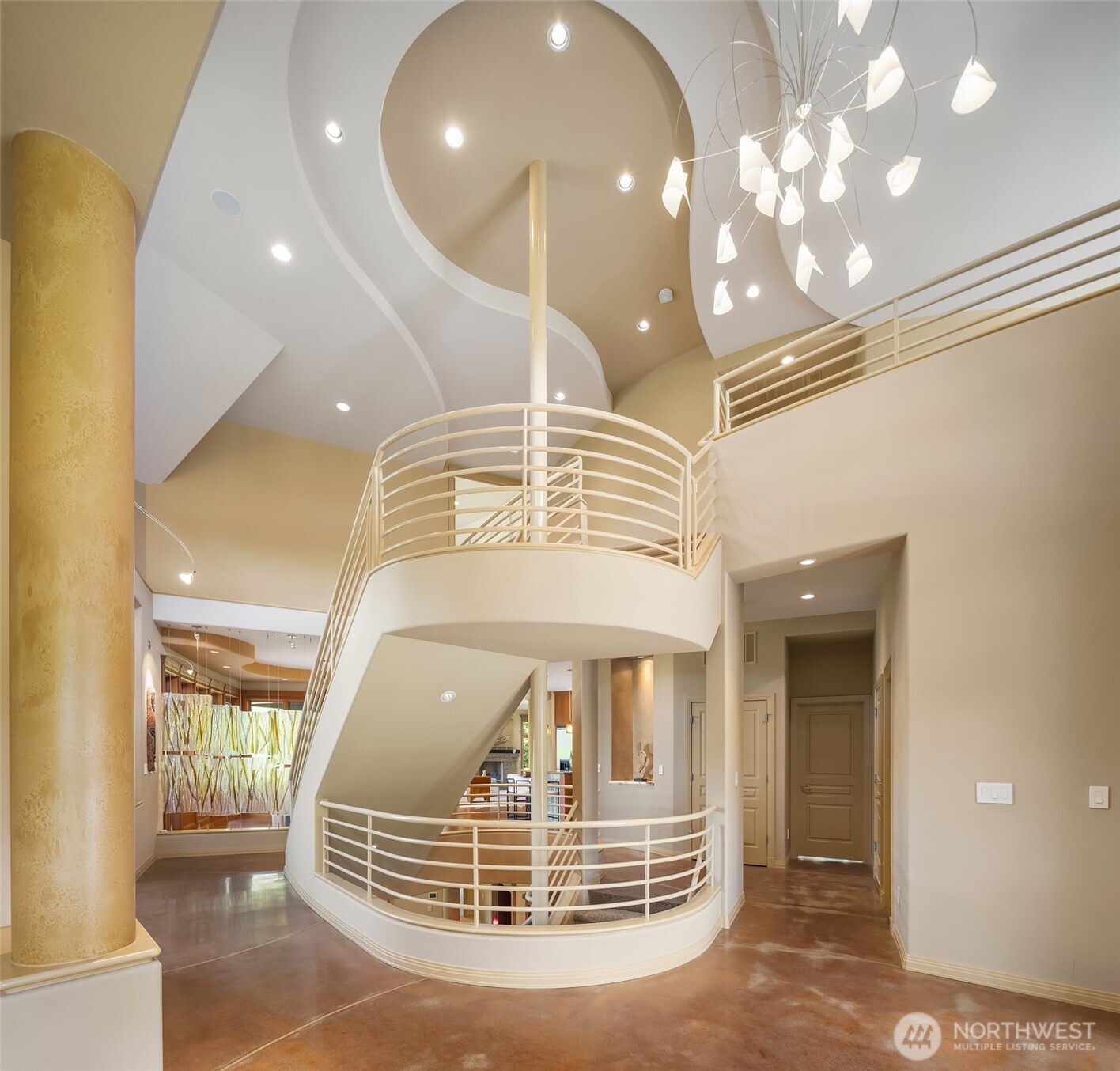 Grand, three story modern metal staircase is a focal point along with art glass accents and heated concrete floors thru-out the main level.