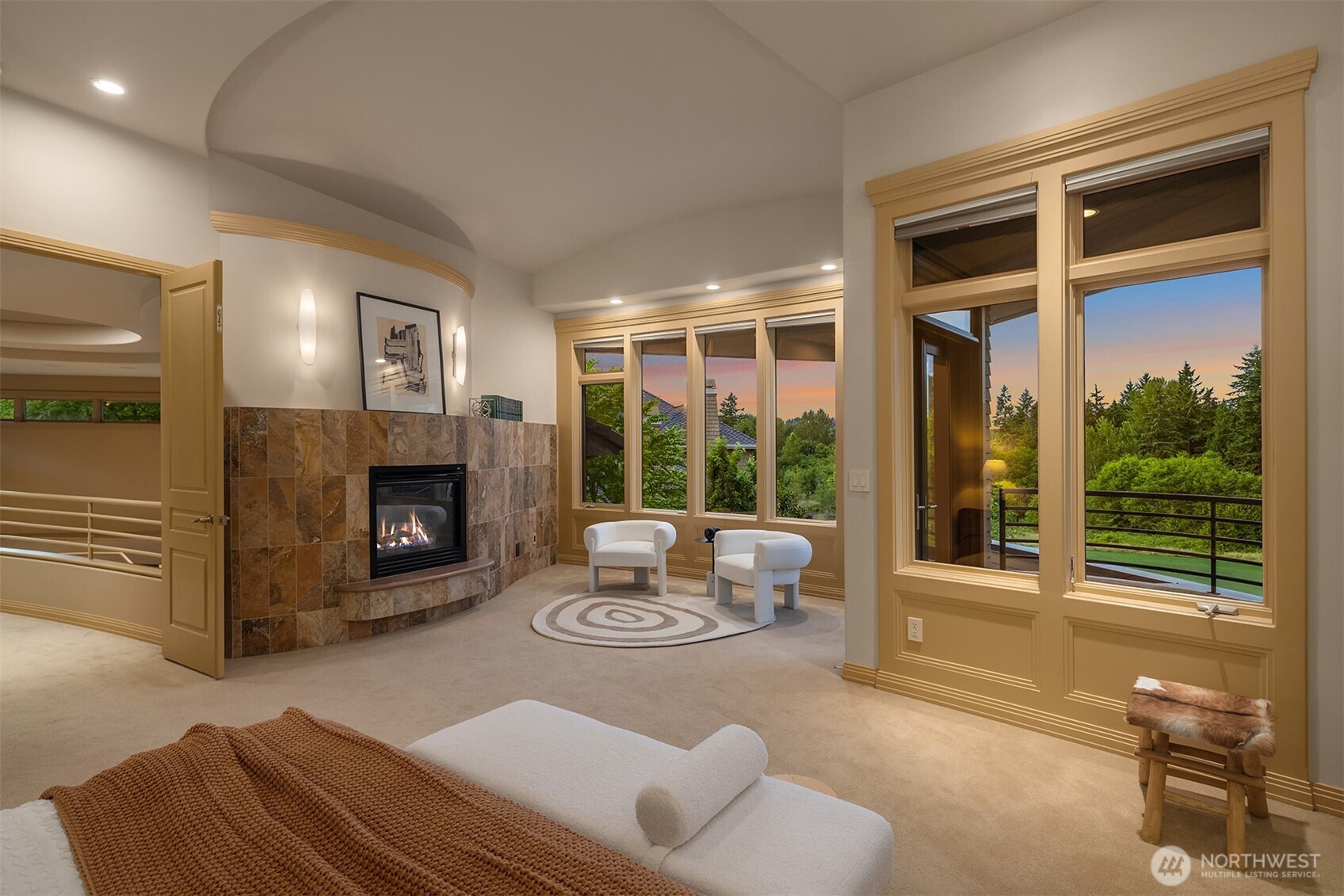 Upstairs find luxury primary bedroom suite wrapped in rich views, anchored by gas fireplace and covered deck