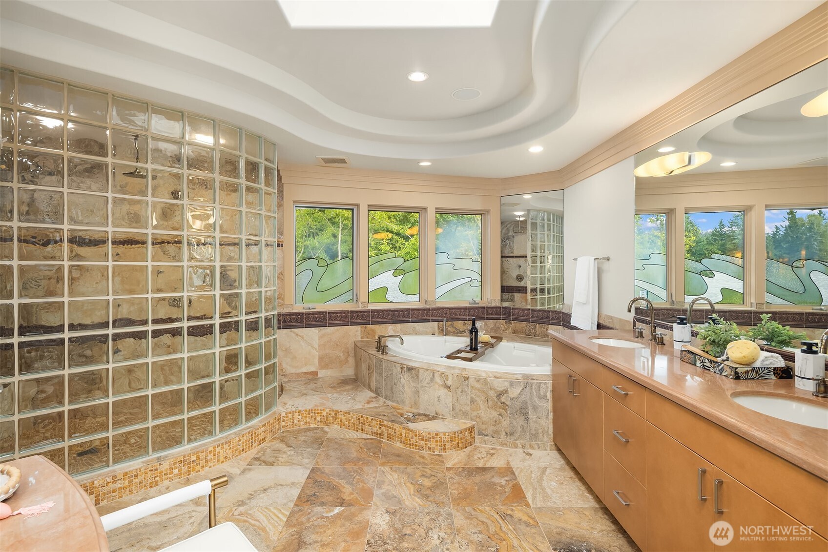 Five piece, tiled, sky-lit spa bath with oversized walk-in shower, jetted soaking tub, dual sinks and separate vanity