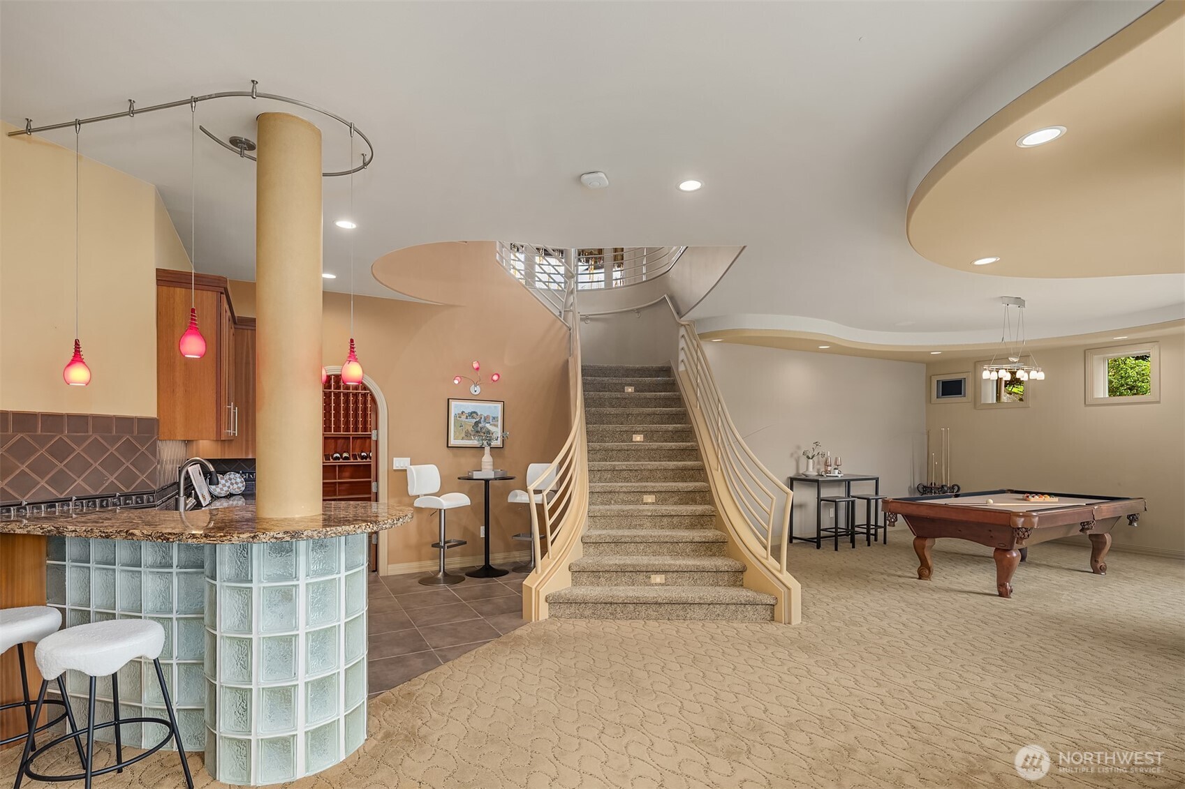 Downstairs is set up for entertaining with rec room, kitchenette/wet bar with seating, wine cellar