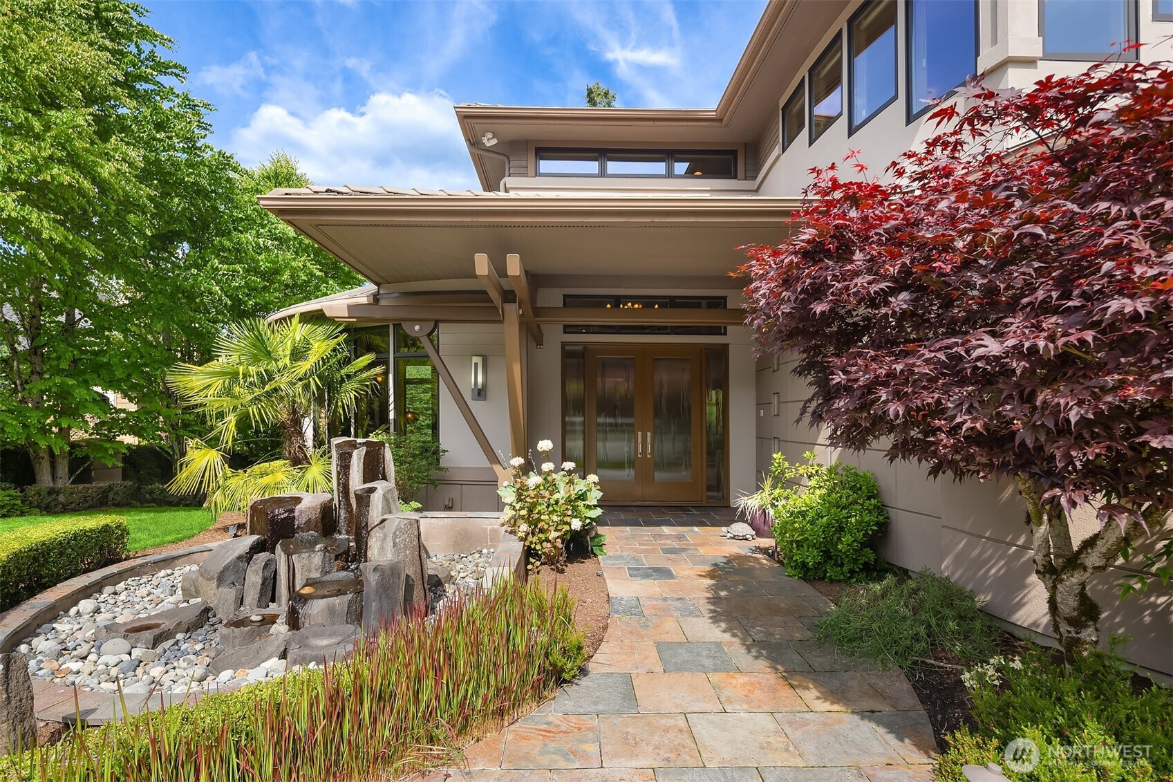 Two stone pillar water features are on the property with one at the entrance welcoming you and the other in the backyard bordering the lower level patio