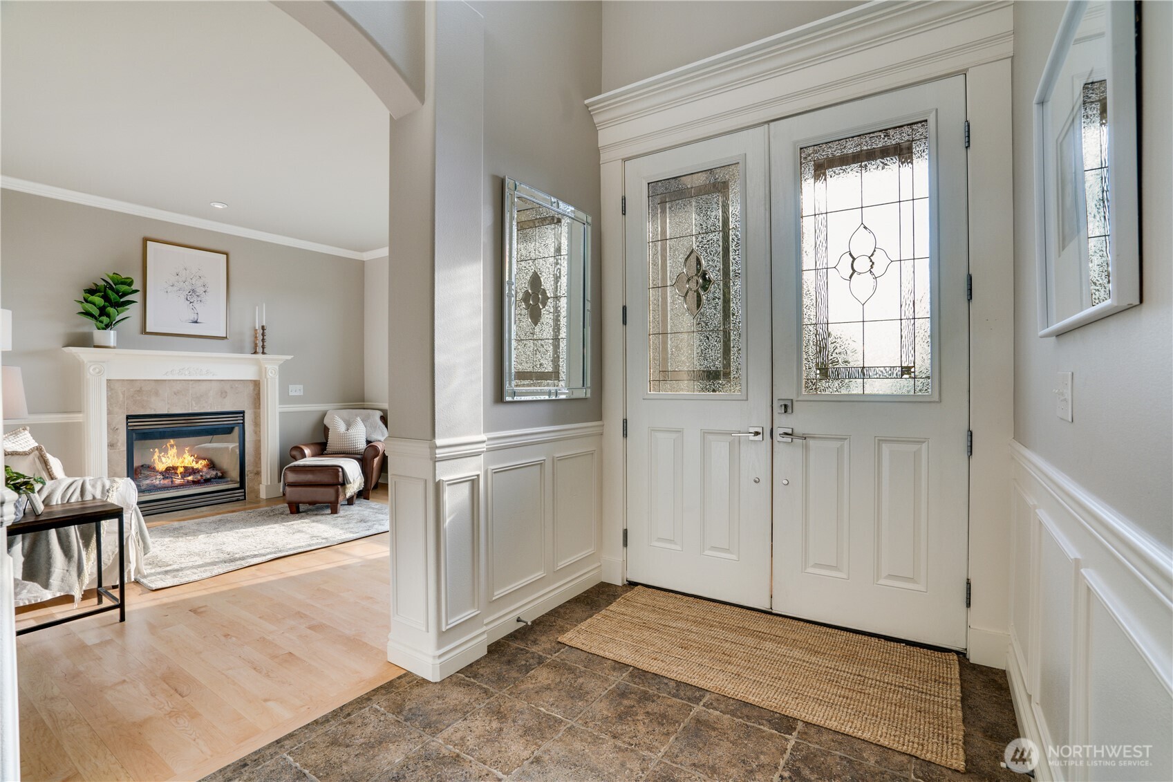 Double door main entry into the home with room for a bench or console.  This was the builders own home and the trim package is over the top.  Living room with gas fireplace off the vaulted entry.