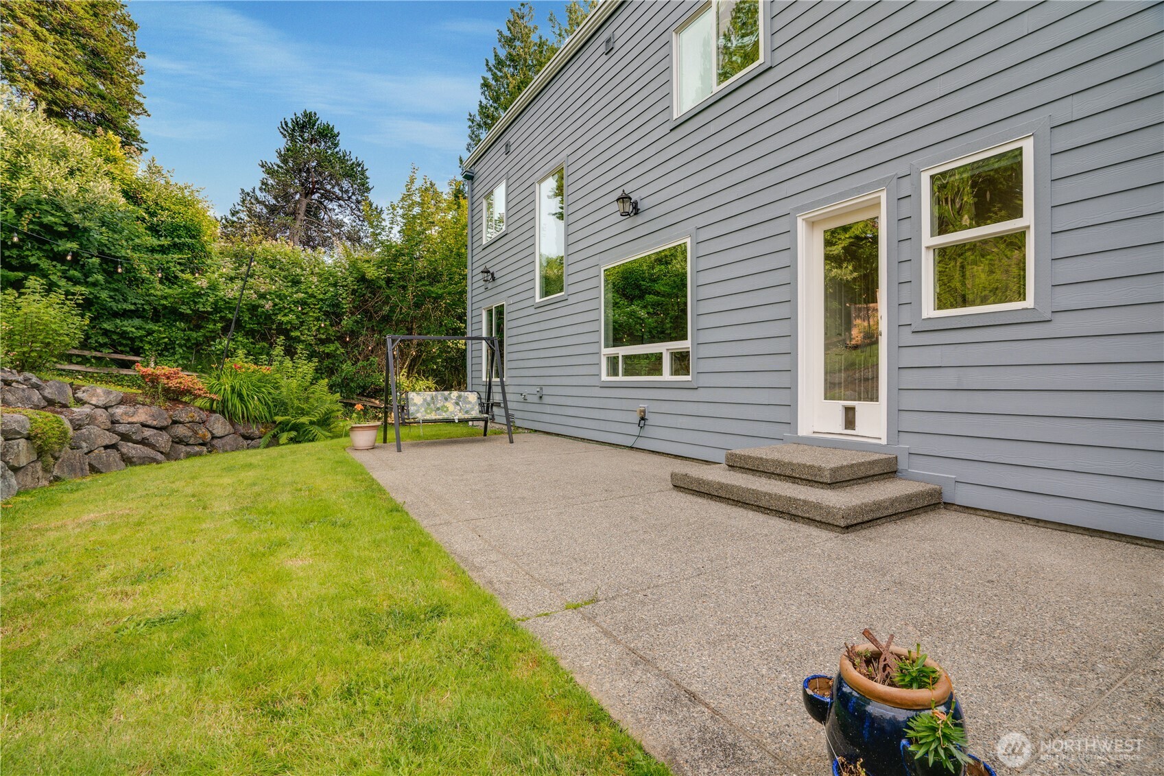 Rear yard with large patio & rock terraces.