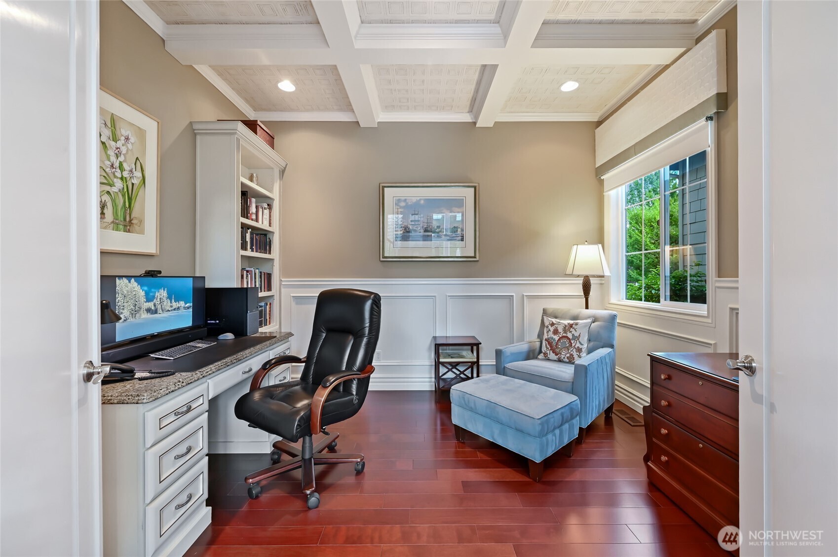 The main floor office includes a built-in desk and bookcases, a coffered tin ceiling and beautiful wainscoting.