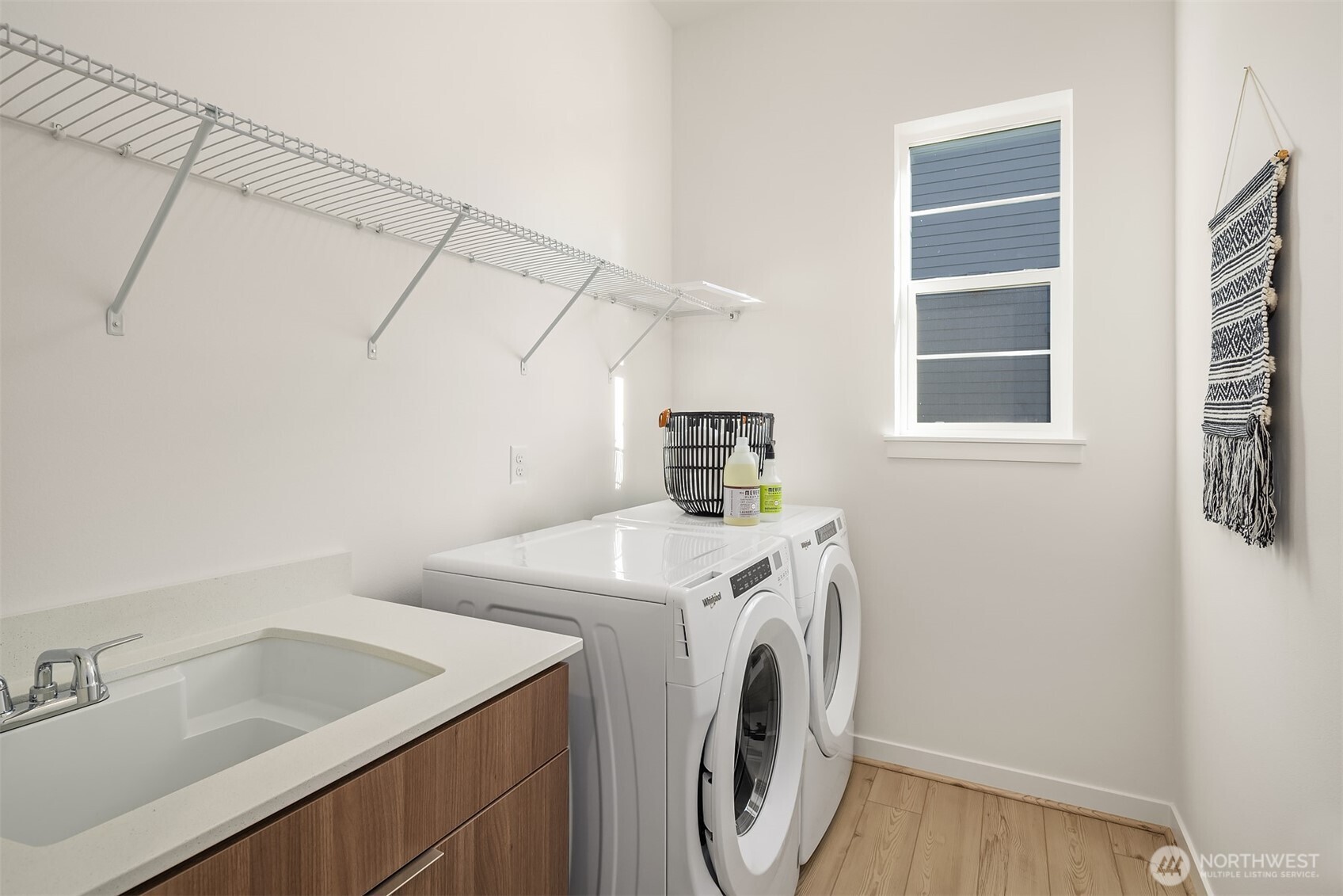 Laundry room includes cabinet with sink, washer & dryer  Photos for illustrative purposes