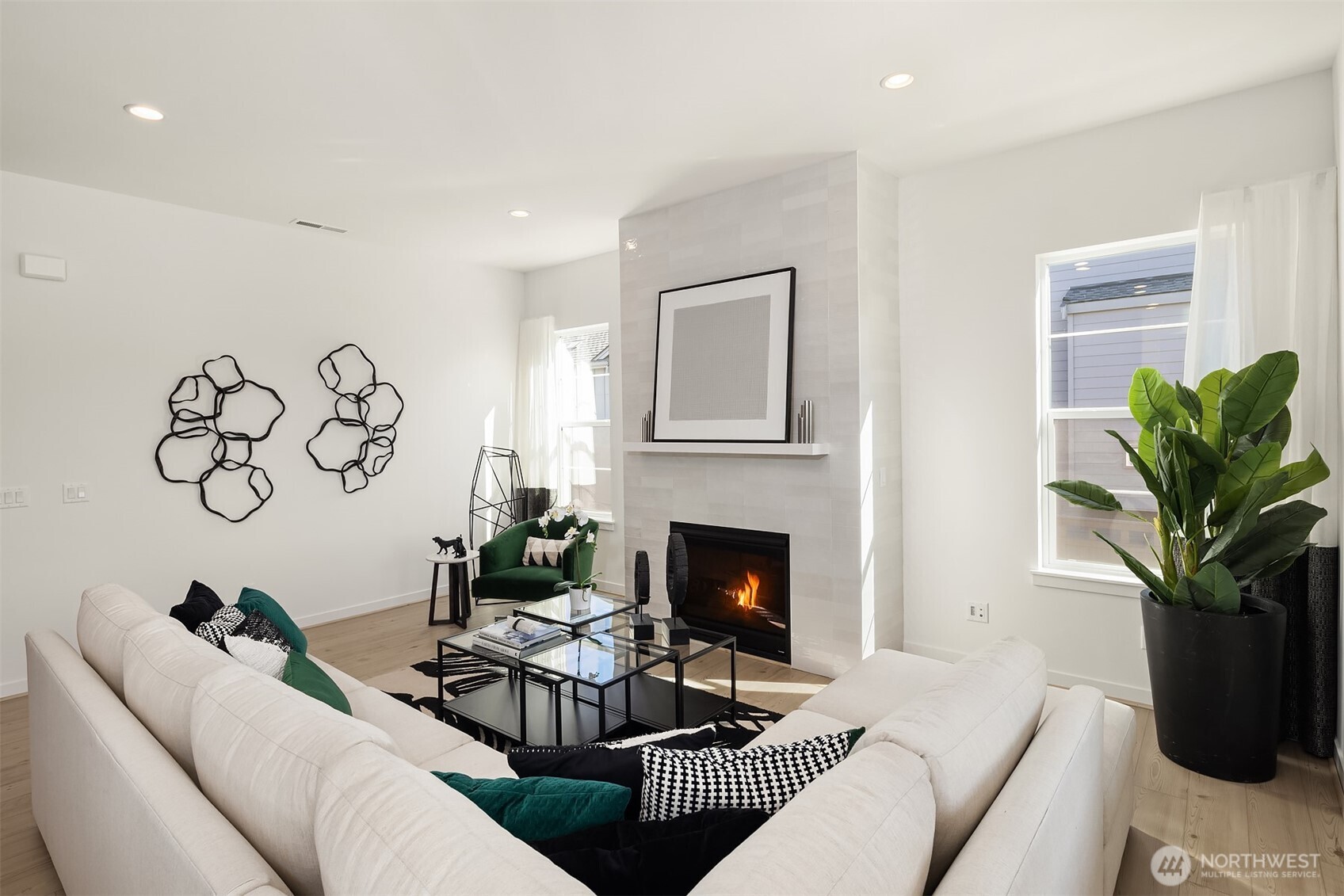 Great room featuring tiled wall fireplace Photos for illustrative purposes