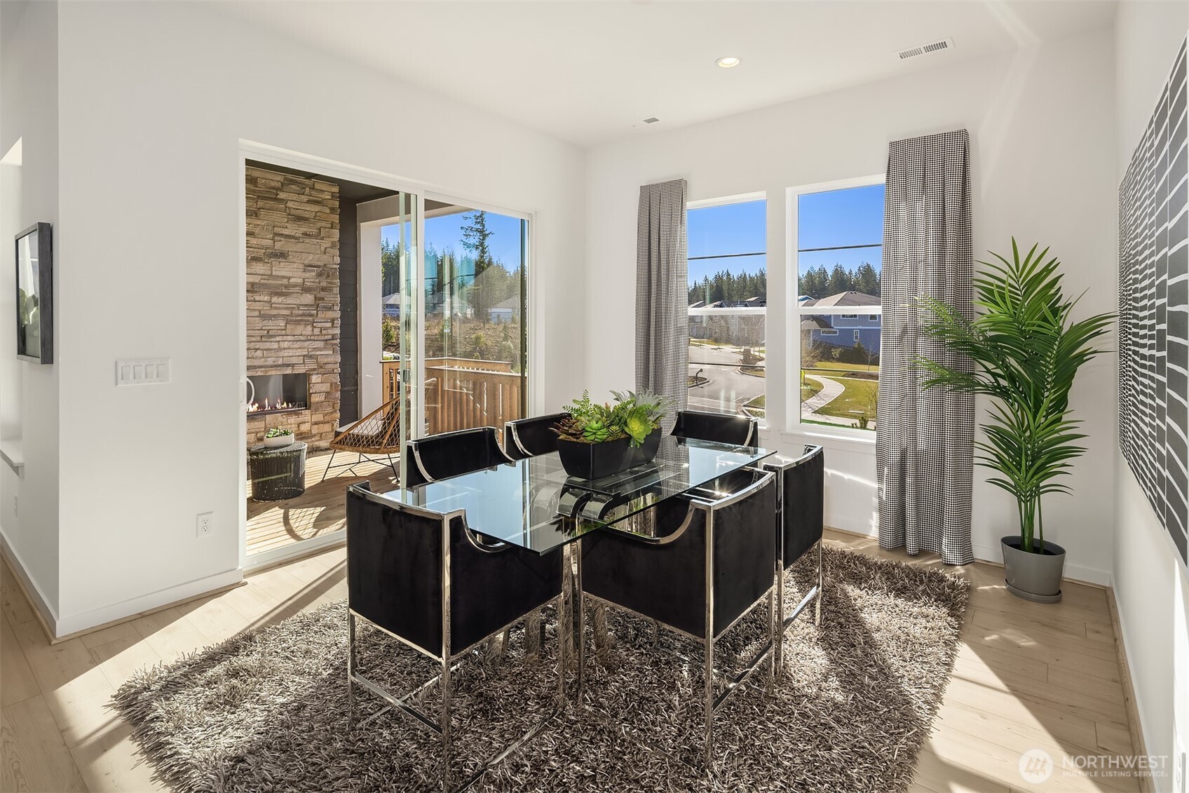 Light-filled dining area that opens to covered deck.  Photos for illustrative purposes