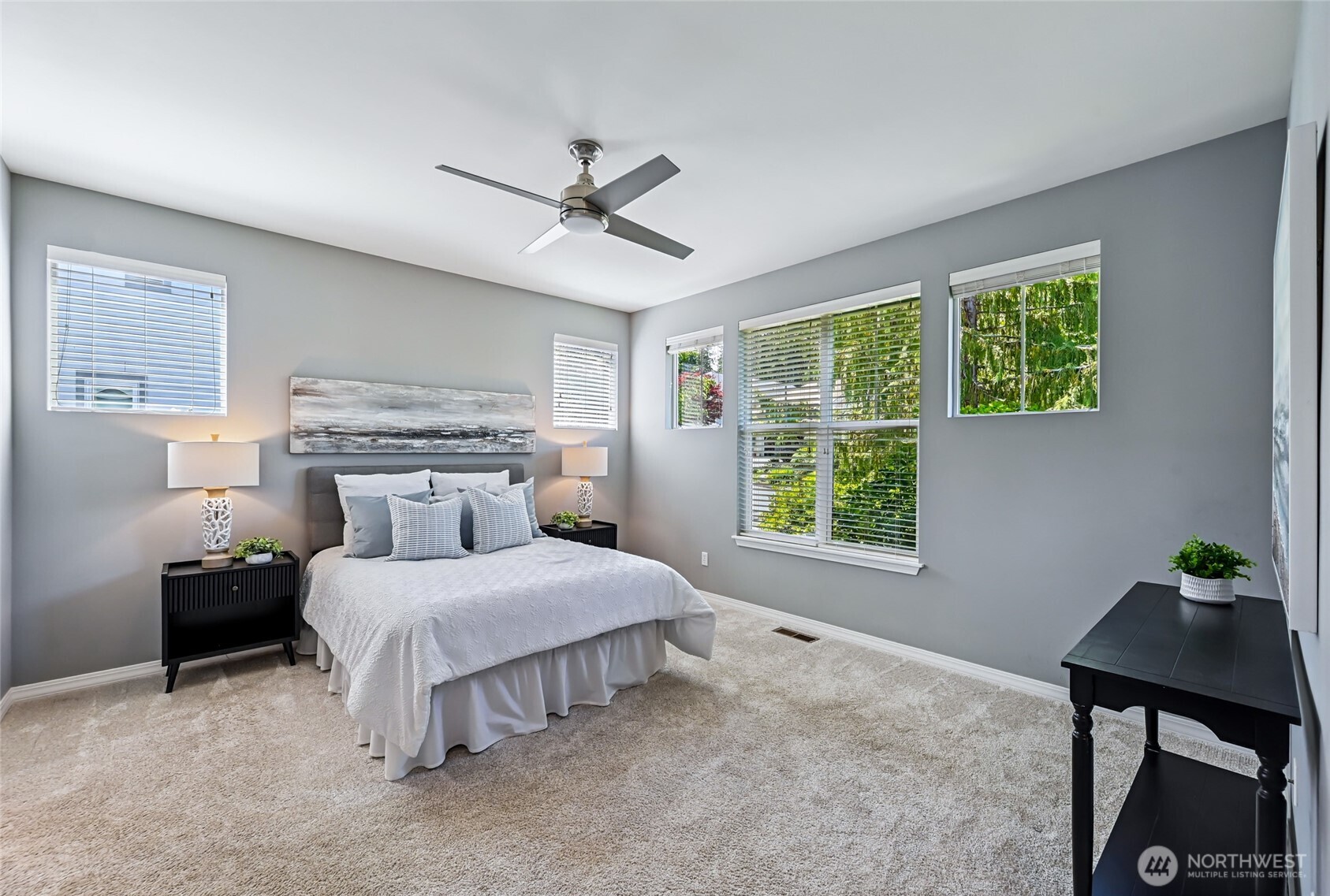 The spacious primary accommodates a king sized bed and full size furniture. Lots of windows bring in natural light.