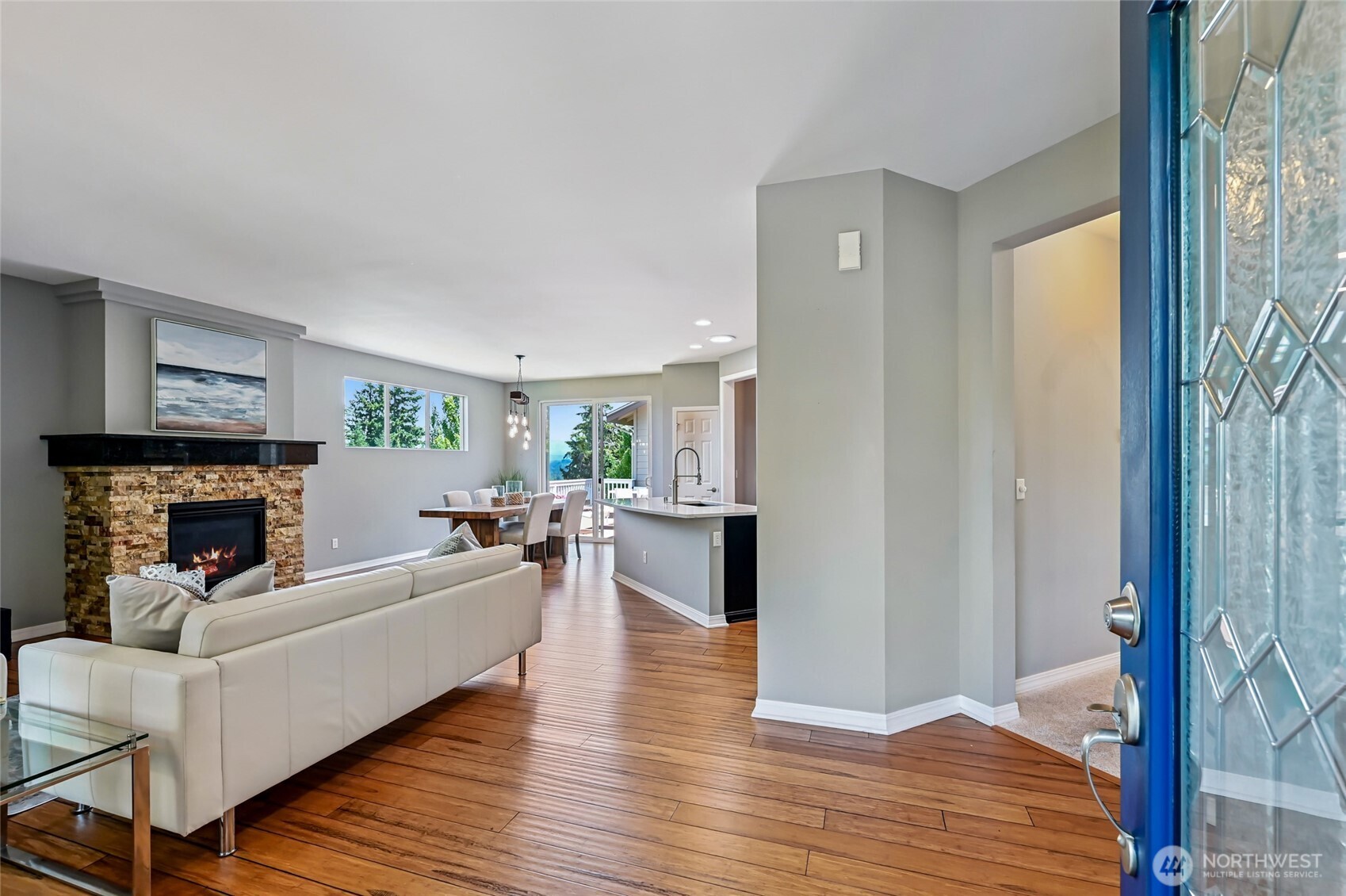 Enter on to wide plank bamboo flooring and you'll immediately notice how light this home is with the three extra windows in the dining room and the double door slider.