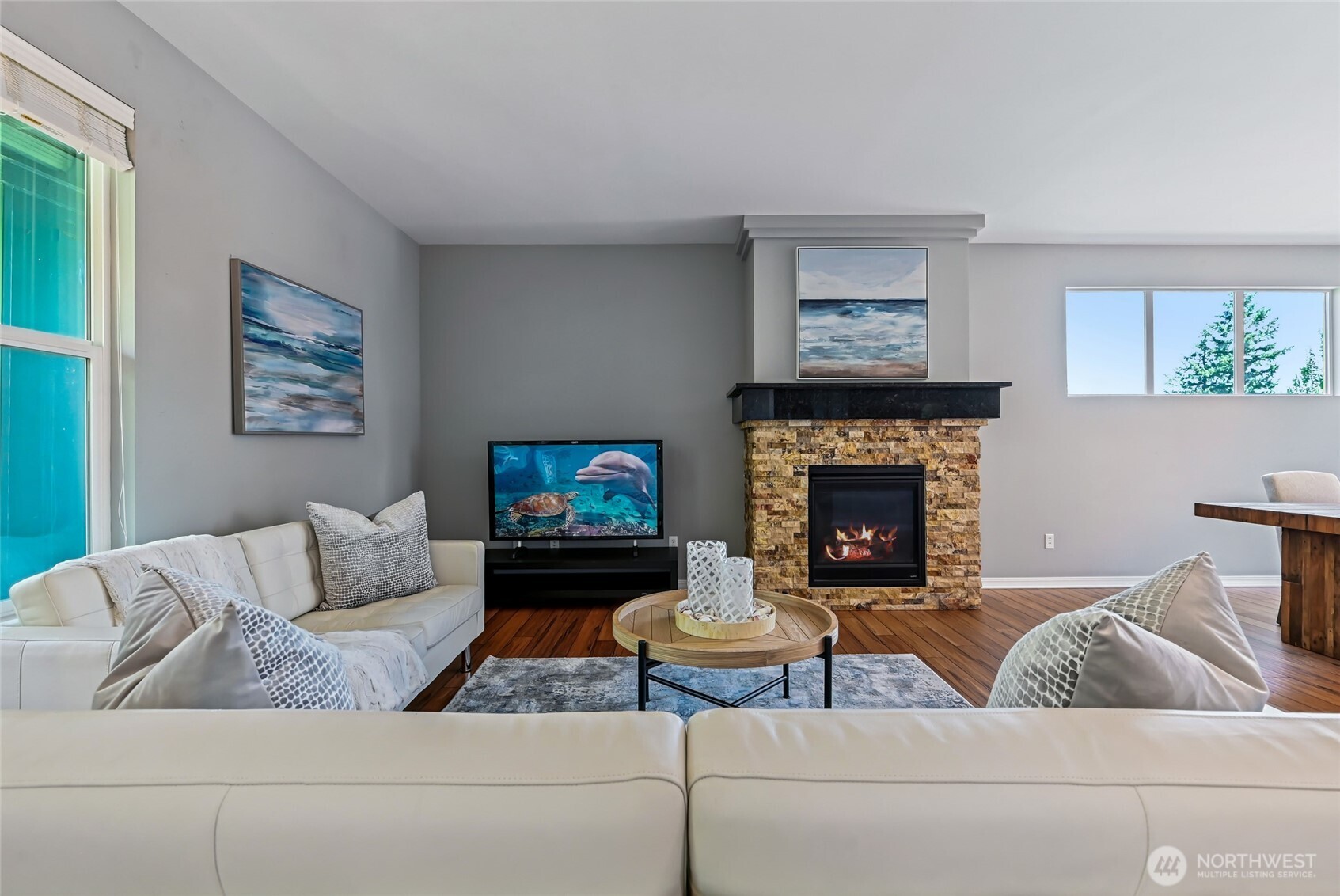 Dramatic stacked stone surrounding the gas fireplace and mantle are the focal point of this room.