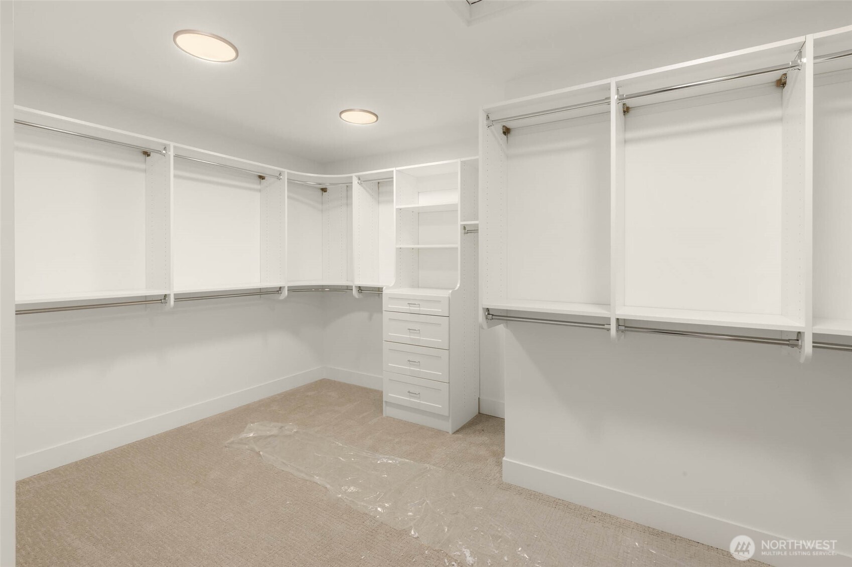 Expansive primary closet with custom solid shelving and built in cabinets. All closets throughout the home feature solid shelving