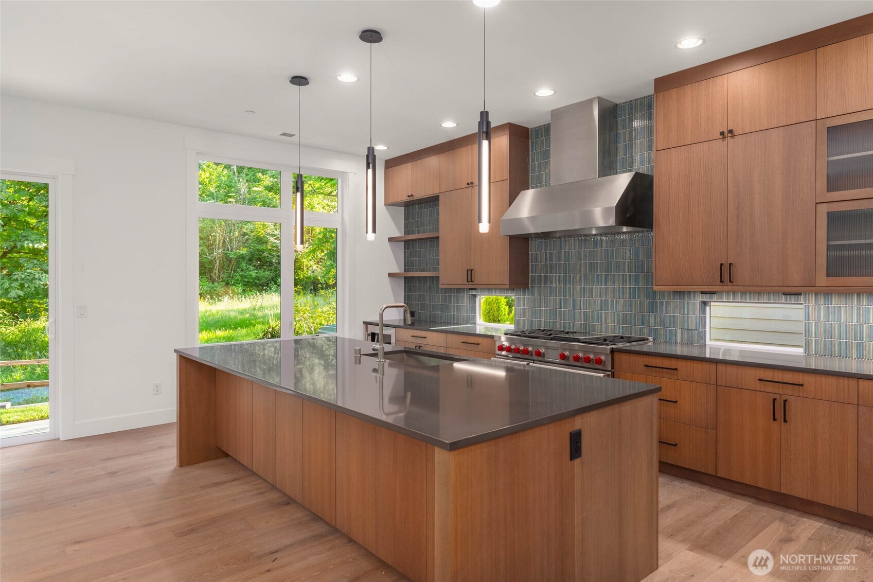 Oversized island with slab quartz and eating bar.