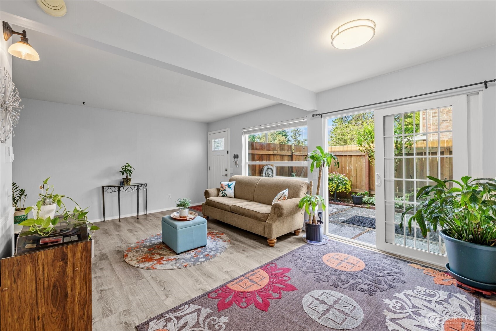 The living room flows effortlessly to the private, fenced patio—extending your space and creating a serene spot for summer nights.