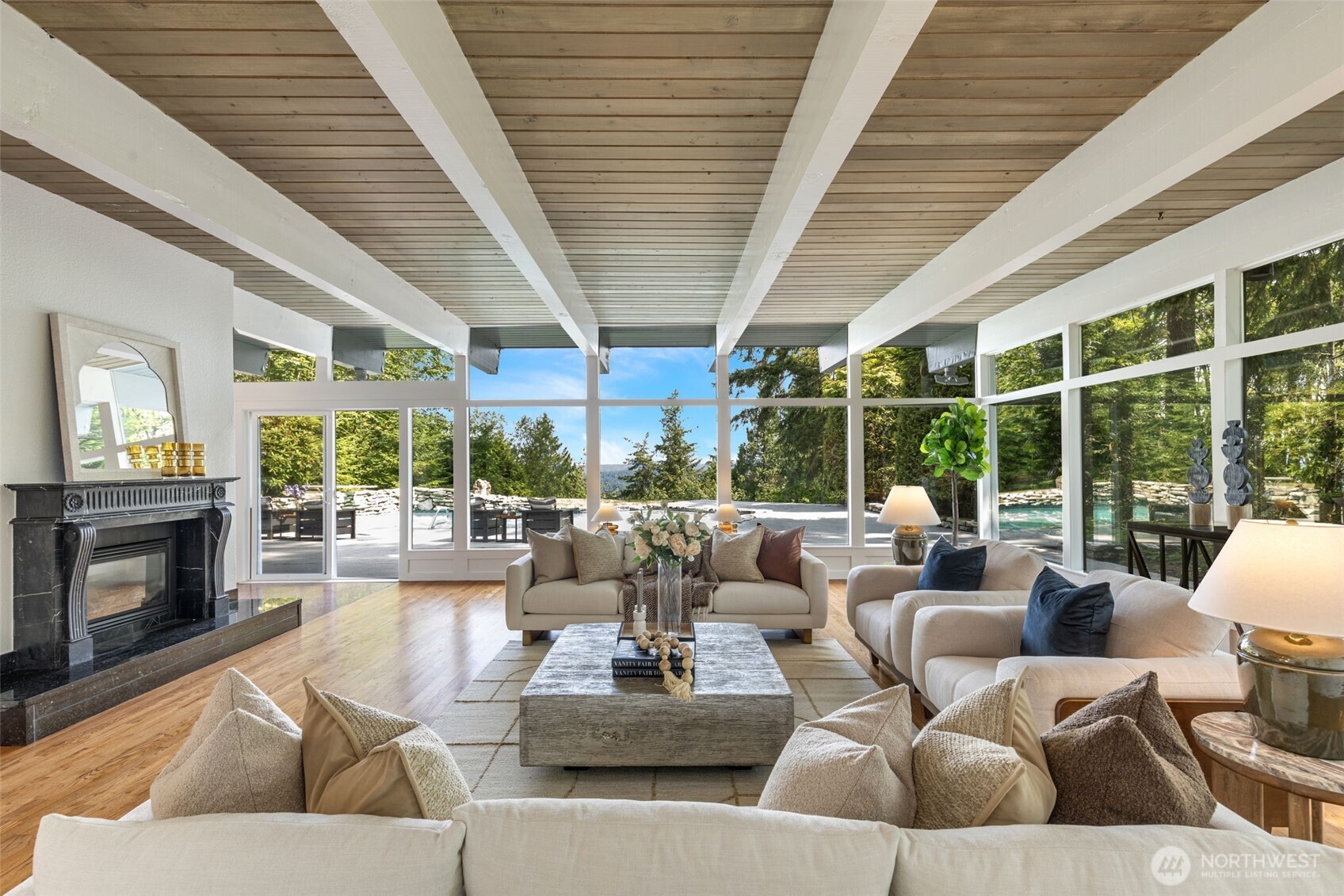A Pacific North West favorite: Rambler design with walls of windows and high ceilings, and partial views of Lake Sammamish, city, and mountains.