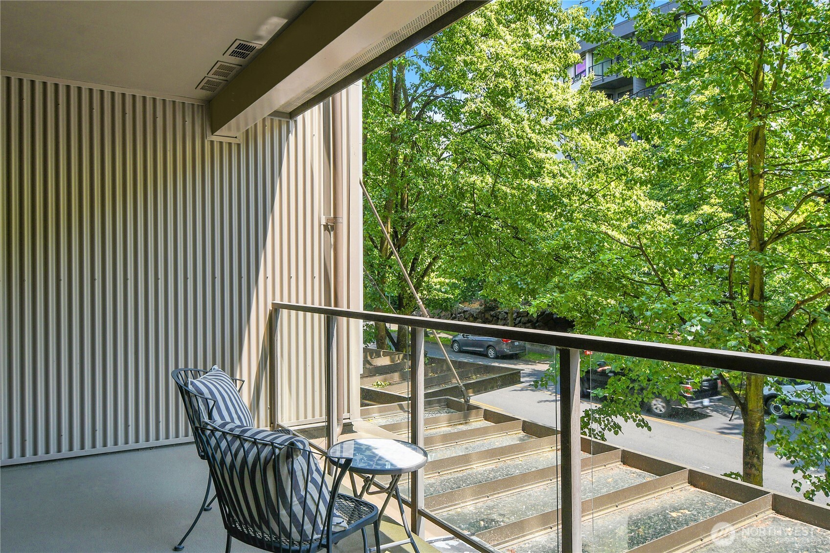 Serene covered deck with beautiful trees provides a year round retreat